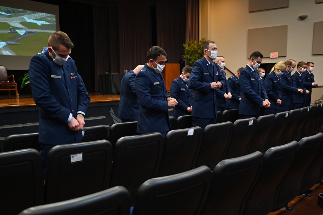 Graduates from Specialized Undergraduate Pilot Training Class 21-09 break their first pair of pilot wings, May 7, 2021, on Columbus Air Force Base, Miss. The pilot tradition entails snapping their first set of wings into two, never to be brought together again while the pilot is alive. One half is kept by the pilot, while the other half is kept by the pilot’s loved one. (U.S. Air Force photo by Senior Airman Jake Jacobsen)