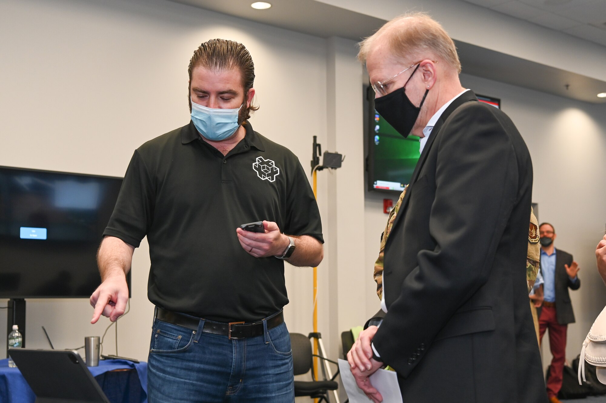 John Boucard, left, Tesseract Ventures CEO, speaks to Steve Wert, program executive officer for Digital, during the Lantern Spring Demo Days at Hanscom Air Force Base, Mass., May 7.