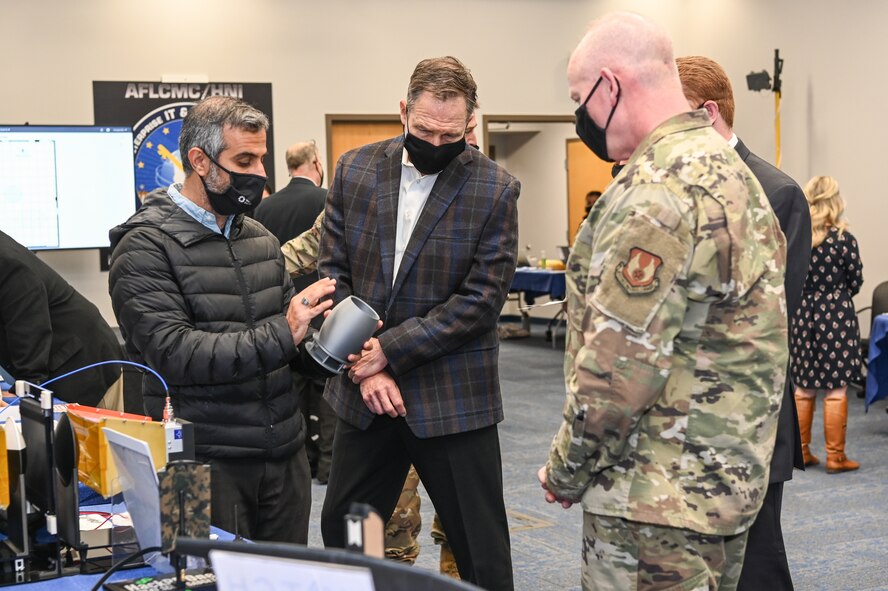 Shahriar Khushrushahi, left, Ph.D, Notch founder and CEO, shows Maj. Gen. Michael Schmidt, program executive officer for Command, Control, Communications, Intelligence and Networks, a model unmanned aircraft system antenna during the Lantern Spring Demo Days at Hanscom Air Force Base, Mass., May 7.