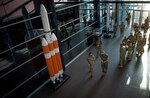 U.S. Marine Corps Master Gunnery Sgt. Scott Stalker welcomes Chief Master Sergeant of the Air Force JoAnne Bass to U.S. Space Command headquarters May 7 at Peterson Air Force Base, Colorado.