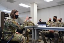 Chief Bass sits with the 50th Force Support Squadron personnel