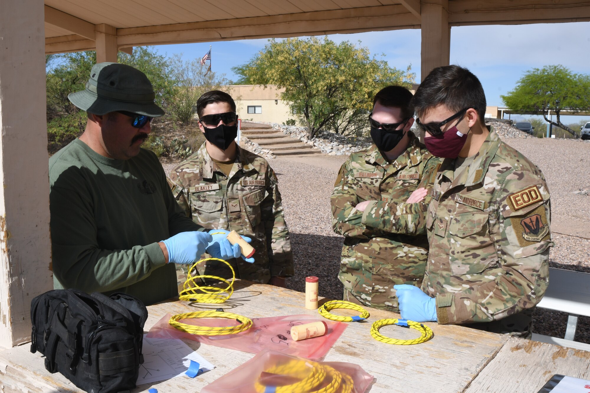 A picture of Airman and a member of the Tucson Bomb Squad preparing explosives for demolition training