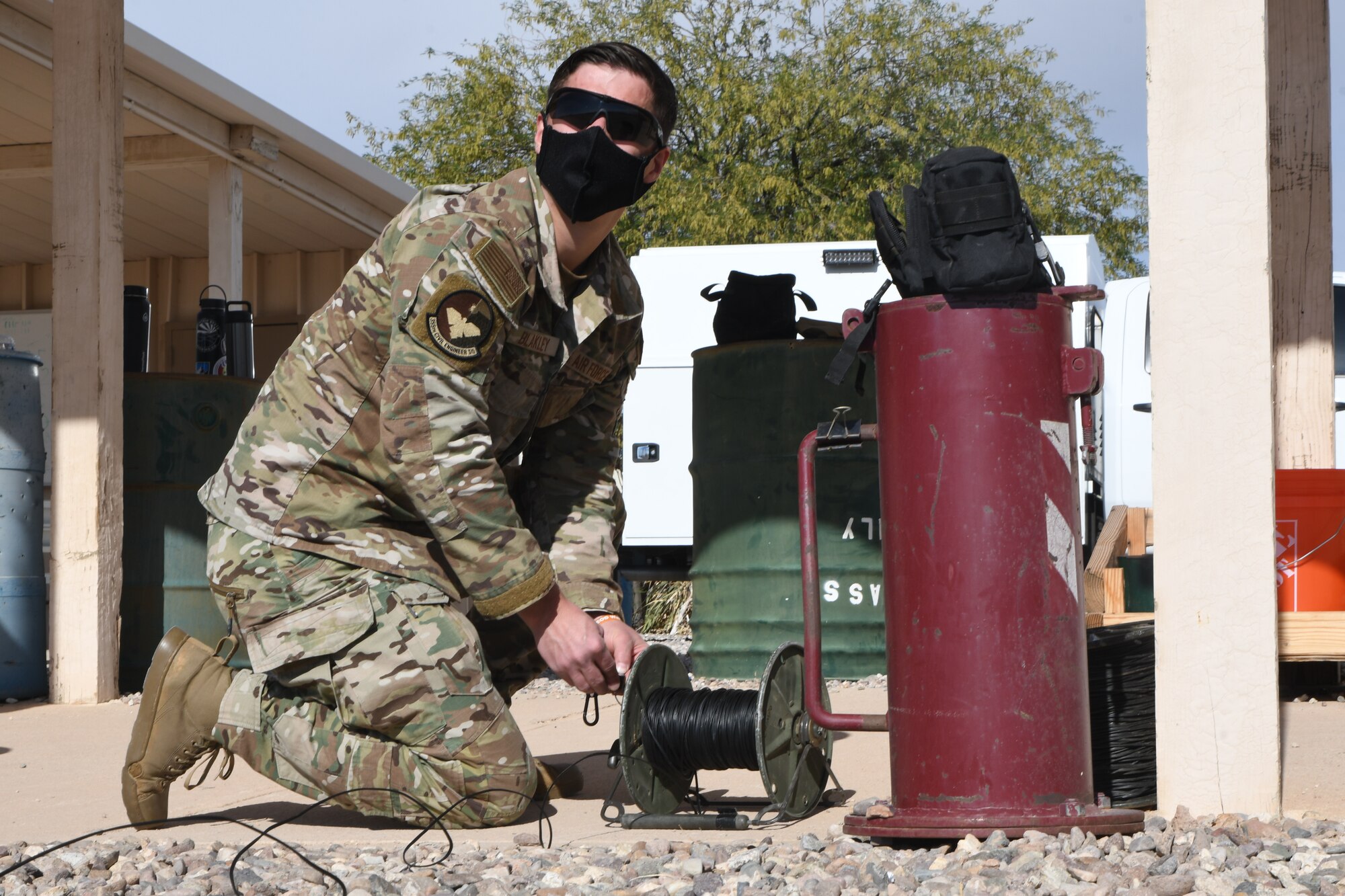 A picture of an Airman rolling firing wire