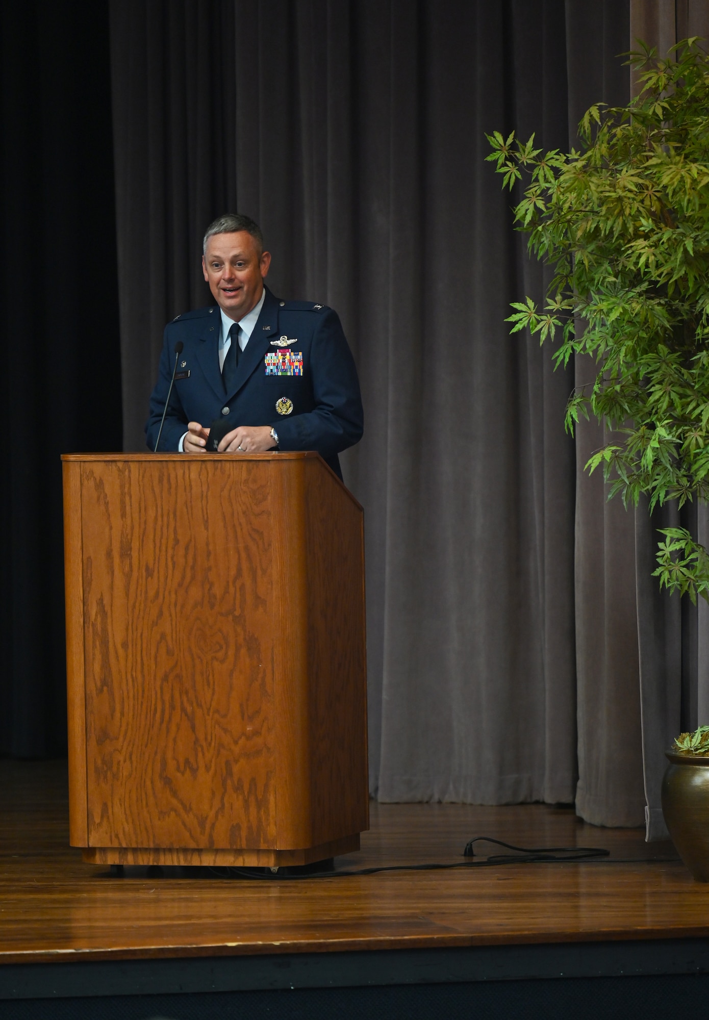 Col. Corey Simmons, 60th Air Mobility Wing commander, speaks at the Specialized Undergraduate Pilot Training Class 21-09 graduation ceremony, May 7, 2021, on Columbus Air Force Base, Miss. As Commander, Simmons is responsible for the combined efforts of all wing operations and support activities associated with the worldwide air mobility mission. (U.S. Air Force photo by Senior Airman Jake Jacobsen)