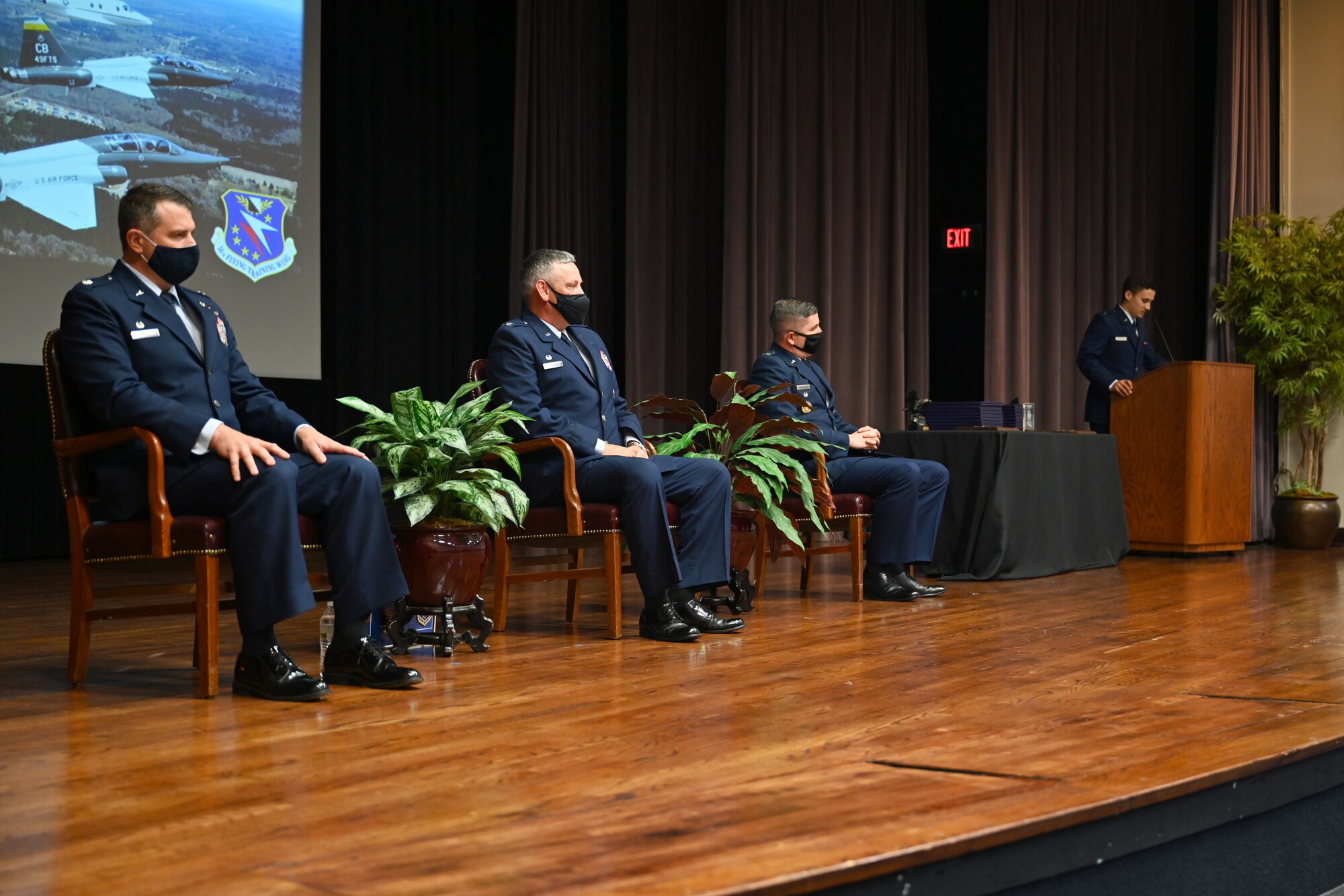 Lt. Col. Joe McCane (left), 14th Student Squadron commander, Col. Corey Simmons (center), 60th Air Mobility Wing commander, and Col. David Fazenbaker, 14th Flying Training Wing vice commander, sit during the Specialized Undergraduate Pilot Training Class 21-09 graduation ceremony, May 7, 2021, on Columbus Air Force Base, Miss. Some selected officers will stay at Columbus AFB, entrusted with the position of First Assignment Instructor Pilot to continue the training of world-class aviators. (U.S. Air Force photo by Senior Airman Jake Jacobsen)