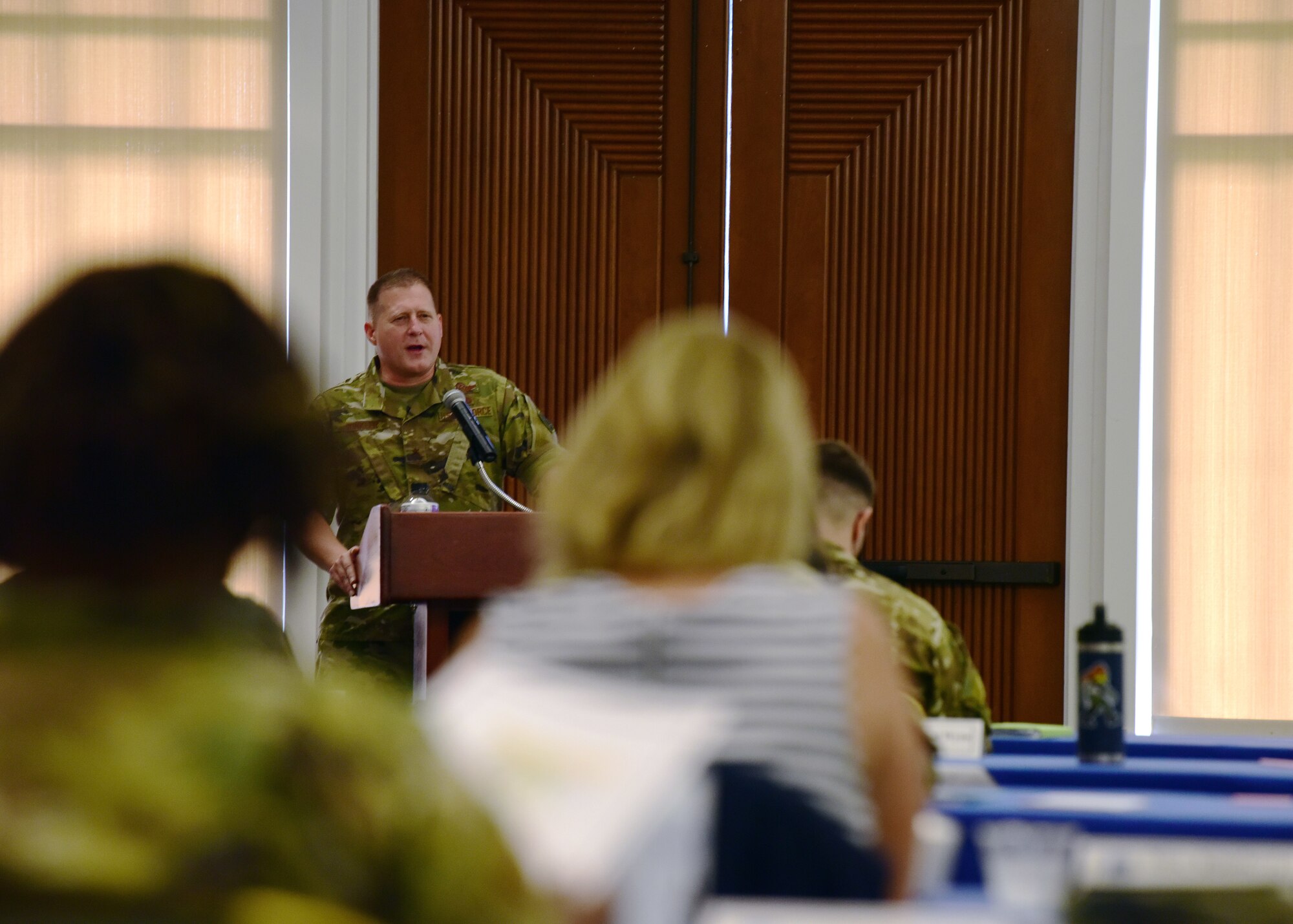 Photo of a U.S. Air Force general briefing Airmen and Spouses