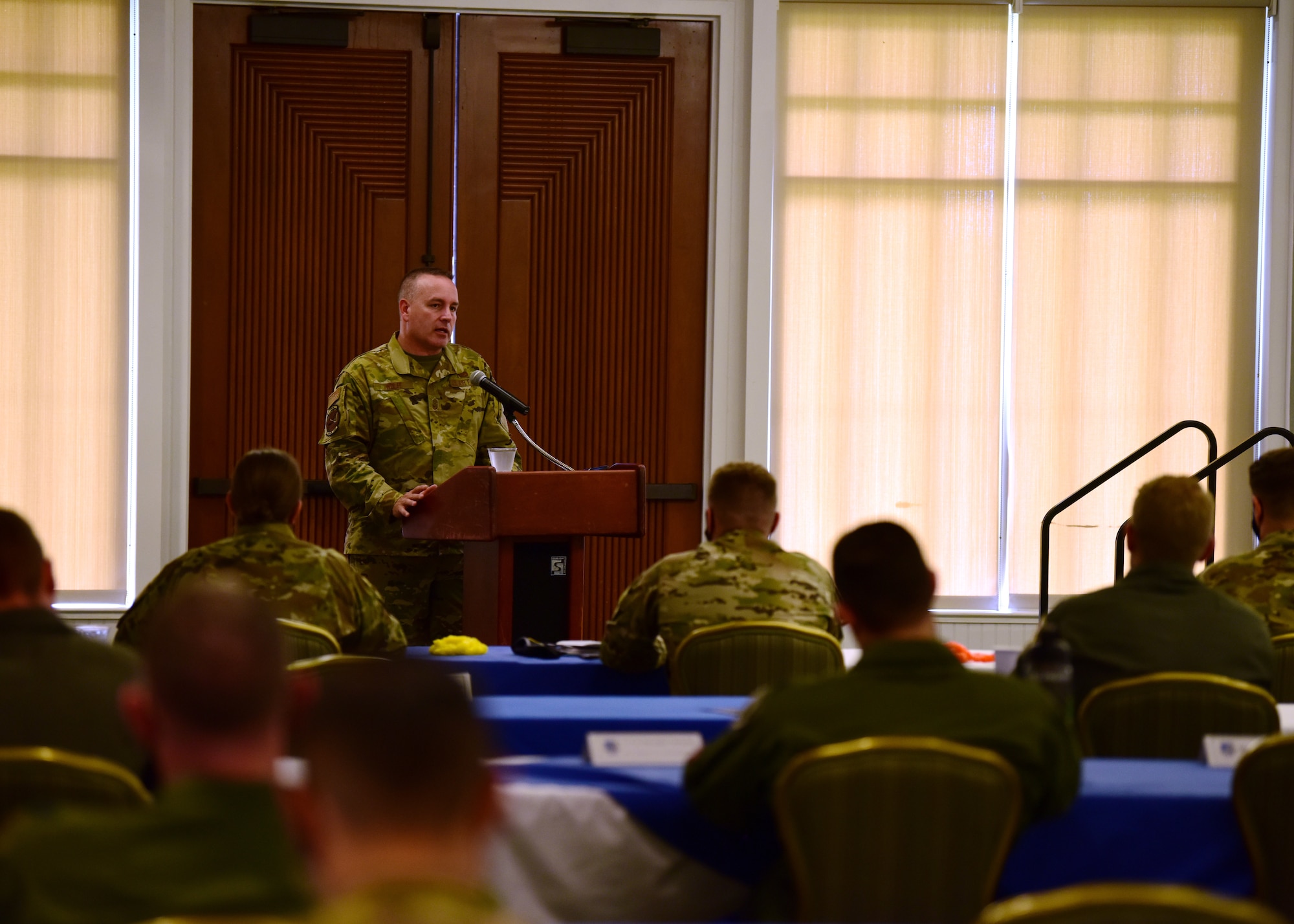 Photo of U.S. Air Force chief master sergeant briefing commanders.