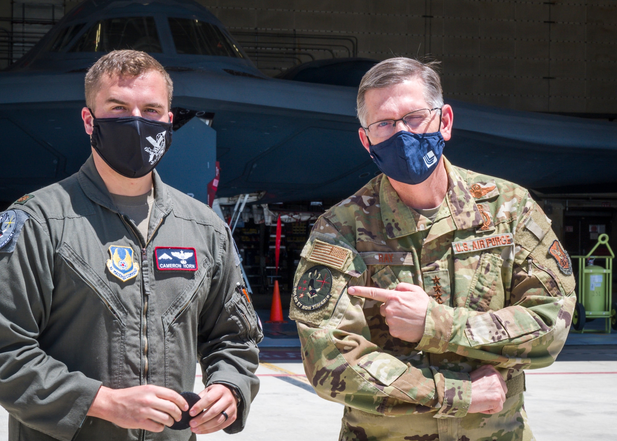 Maj. Cameron Horn, 419th Flight Test commander, presents Gen. Timothy Ray, Air Force Global Strike Command commander, with a B-2 test program morale patch during his visit to Edwards Air Force Base, California, May 5. The B-2 fleets continued technological advancement enables expanded strike capabilities while ensuring the aircraft can keep pace with evolving threat levels. (Air Force photo by Giancarlo Casem)