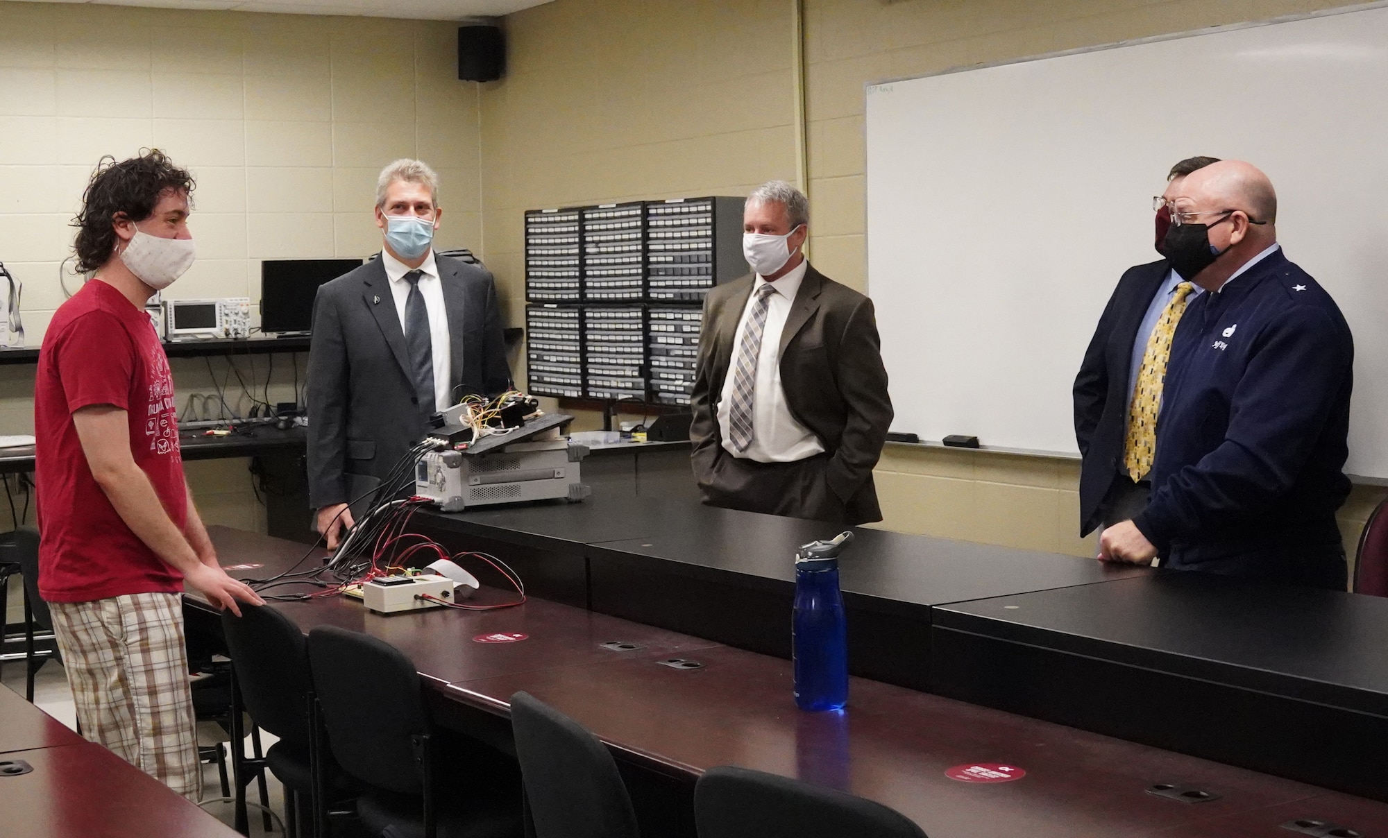 Four men talking in a room