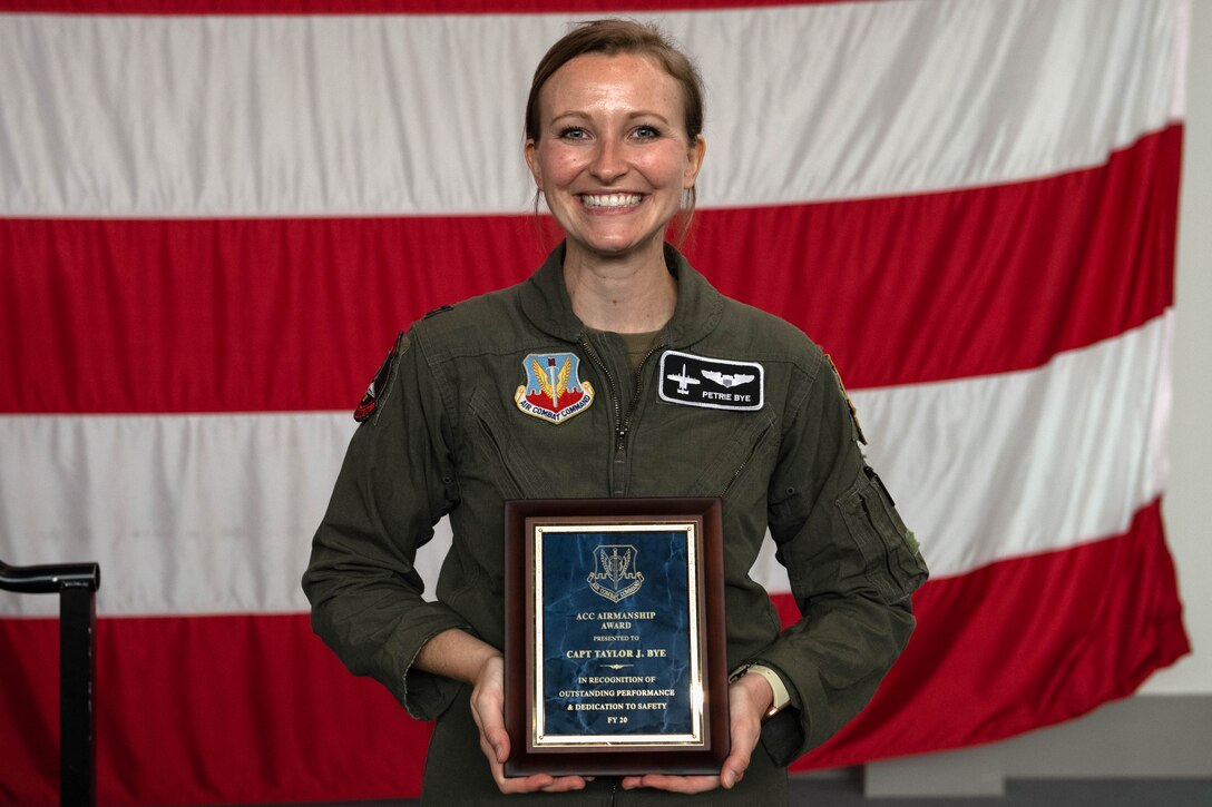 A photo of Captain Bye holding a plaque.