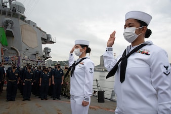 Sailors take the oath of allegiance aboard USS Mustin (DDG 89) to become U.S. citizens.