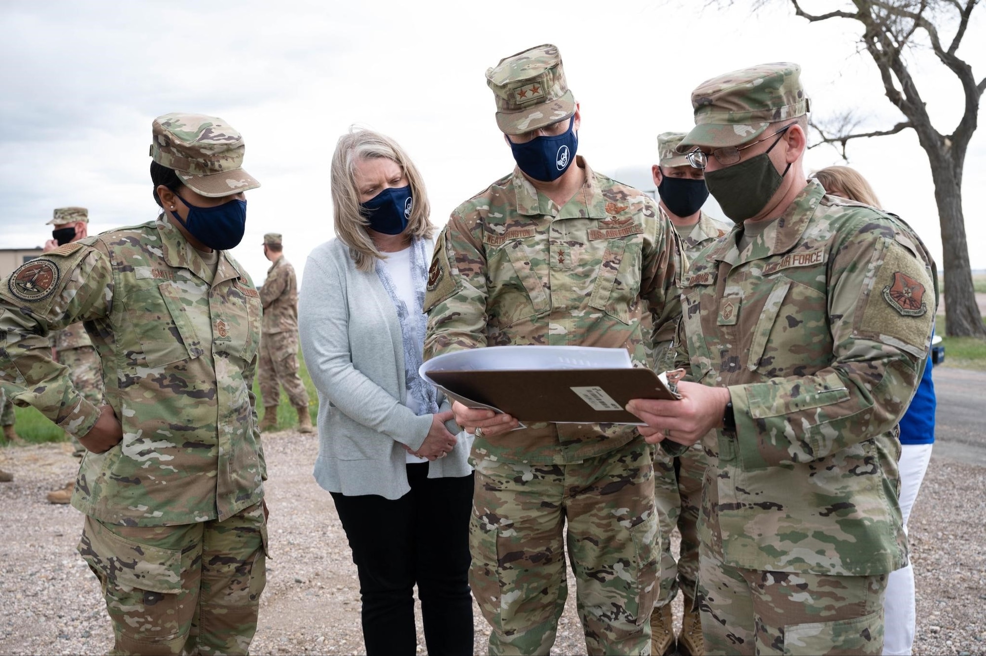 Maj. Gen. Mark Weatherington, 8th Air Force and Joint-Global Strike Operations Center commander, second from right, and Chief Master Sgt. Melvina Smith, 8th Air Force command chief and J-GSOC senior enlisted leader, far left, look over new construction plans for Camp Lancer during their visit to Ellsworth Air Force Base, S.D., May 4, 2021.