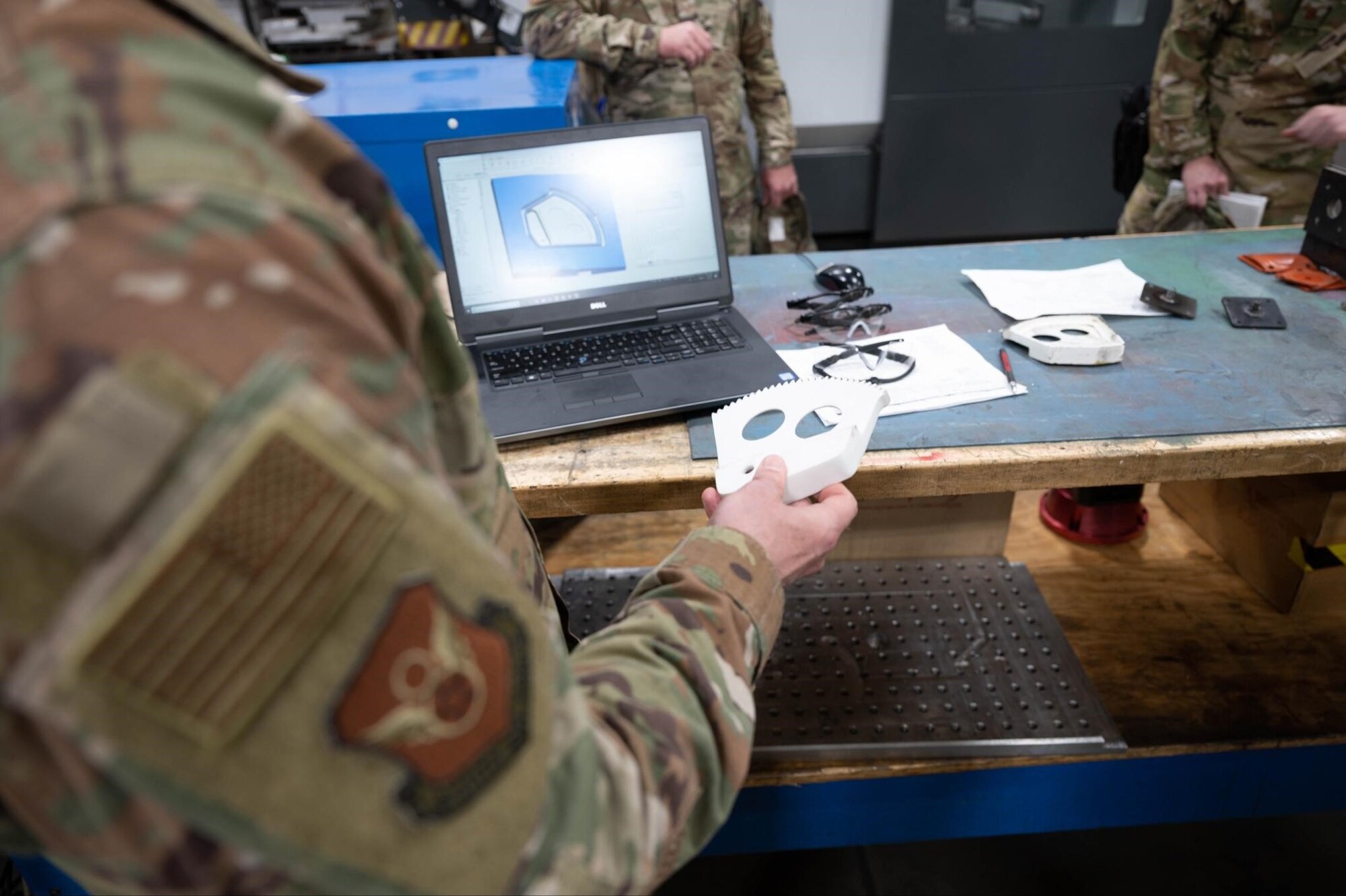 Maj. Gen. Mark Weatherington, the 8th Air Force and Joint-Global Strike Operations Center commander, inspects a 3D printed B-1B Lancer part during his visit to Ellsworth Air Force Base, S.D., May 4, 2021.