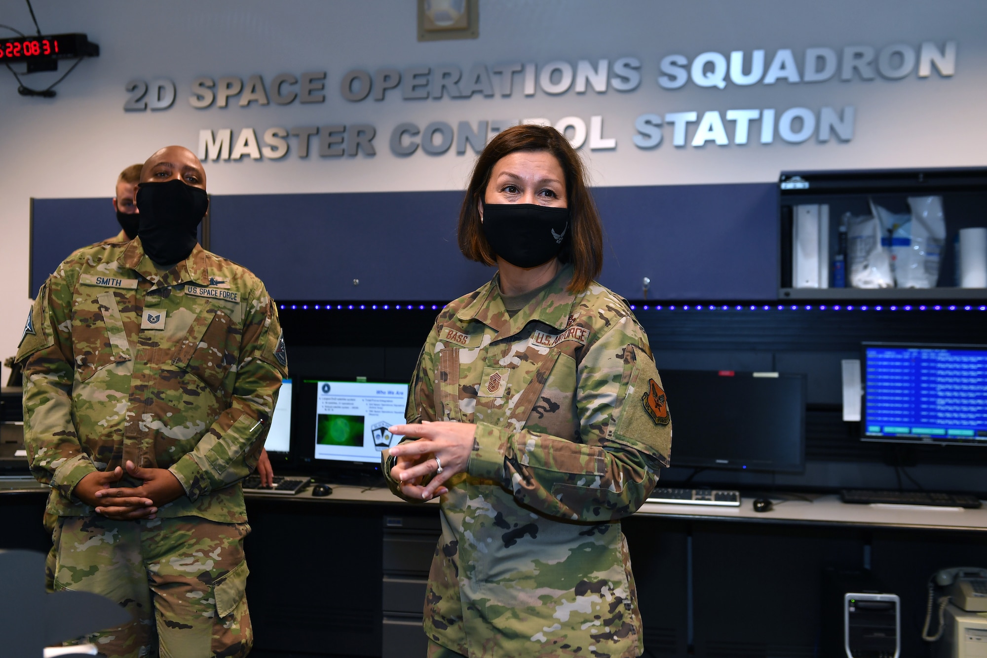 Chief Bass stands with P-S GAR personnel in front of the 2nd Space Operations Squadron sign