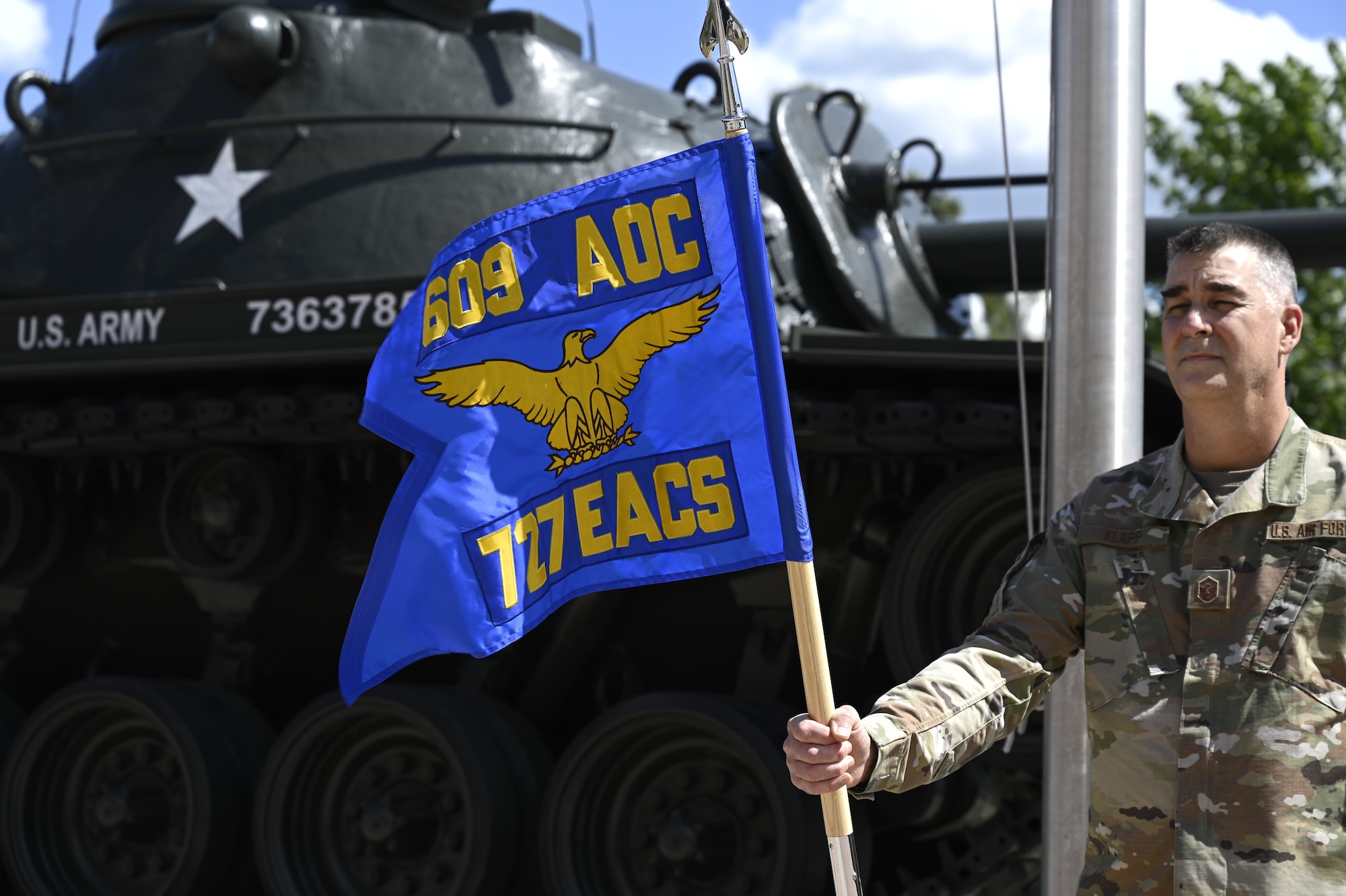 The newly unveiled 727th Expeditionary Air Control Squadron’s flag waves in the wind during a realignment ceremony at Shaw Air Force Base, South Carolina, May 7, 2021. The ceremony was held to unveil the new squadron flag for the 727th EACS, representing their realignment from the 380th Expeditionary Operations Group to the 609th AOC. This move enhances 9th Air Force (Air Forces Central)’s operational resilience and demonstrates advancements in the Air Force’s ability to distribute operations globally. It also provides a unique opportunity to synchronize command and control functions from the tactical to the operational level.  (U.S. Air Force photo by Tech. Sgt E’lysia Wray)