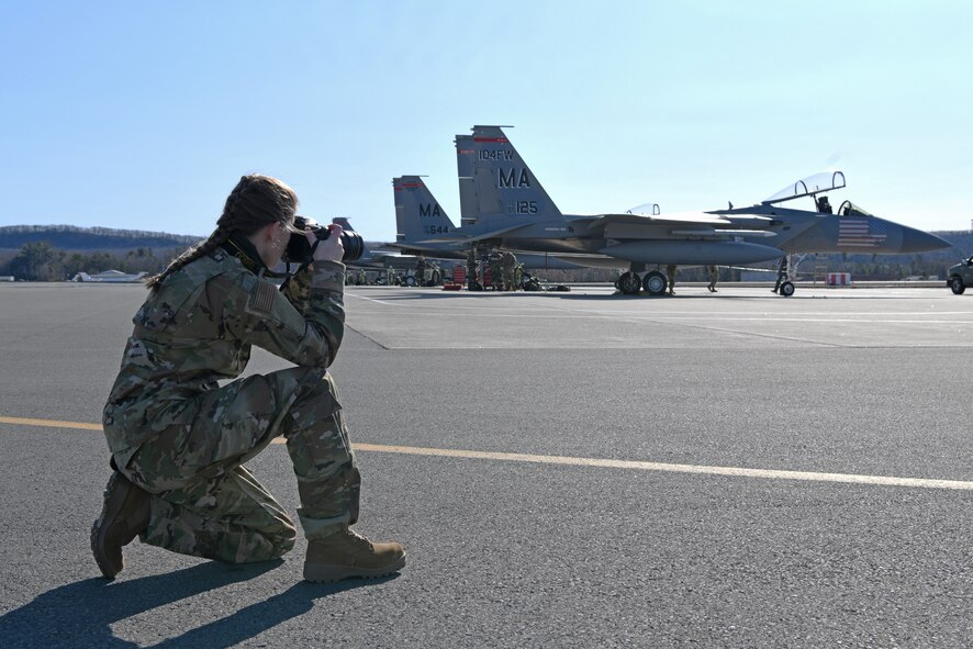 Senior Airman Sara Kolinski, 104th Fighter Wing public affairs specialist, prepares to take a photo on the flightline on Barnes Air National Guard Base, Massachusetts, Mar. 13, 2021. Kolinski was named the Air National Guard Region One Outstanding Airman of the Year for 2020. (U.S. Air National Guard photo by Staff Sgt. Hanna Smith)