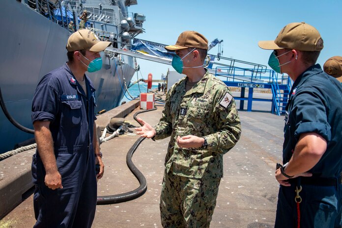 210506-N-VG727-1016 MANAMA, Bahrain (May 6, 2021) Vice Adm. Brad Cooper, commander of U.S. Naval Forces Central Command (NAVCENT), U.S. 5th Fleet and Combined Maritime Forces (CMF), speaks with Boatswain’s Mate 1st Class Nicholas Geisler, left, and Boatswain’s Mate 2nd Class Dillon Sharer, assigned to Arleigh Burke-class guided-missile destroyer USS Thomas Hudner (DDG 116), during a port call in Manama, Bahrain, May 6. Thomas Hudner is deployed to the U.S. 5th Fleet area of operations and conducting naval operations to ensure maritime stability and security in the Central Region, connecting the Mediterranean and the Pacific through the western Indian Ocean and three strategic choke points. (U.S. Navy photo by Mass Communication Specialist 2nd Class William Collins III)