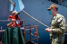 210506-N-VG727-1031 MANAMA, Bahrain (May 6, 2021) Vice Adm. Brad Cooper, commander of U.S. Naval Forces Central Command (NAVCENT), U.S. 5th Fleet and Combined Maritime Forces (CMF), speaks with Seaman Moses Rodriguez, assigned to Arleigh Burke-class guided-missile destroyer USS Thomas Hudner (DDG 116), during a port call in Manama, Bahrain, May 6. Thomas Hudner is deployed to the U.S. 5th Fleet area of operations and conducting naval operations to ensure maritime stability and security in the Central Region, connecting the Mediterranean and the Pacific through the western Indian Ocean and three strategic choke points. (U.S. Navy photo by Mass Communication Specialist 2nd Class William Collins III)