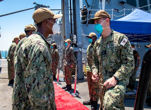 210506-N-VG727-1124 MANAMA, Bahrain (May 6, 2021) Vice Adm. Brad Cooper, commander of U.S. Naval Forces Central Command (NAVCENT), U.S. 5th Fleet and Combined Maritime Forces (CMF), speaks with Seaman Jonathan Tucker, assigned to Arleigh Burke-class guided-missile destroyer USS Thomas Hudner (DDG 116), during a port call in Manama, Bahrain, May 6. Thomas Hudner is deployed to the U.S. 5th Fleet area of operations and conducting naval operations to ensure maritime stability and security in the Central Region, connecting the Mediterranean and the Pacific through the western Indian Ocean and three strategic choke points. (U.S. Navy photo by Mass Communication Specialist 2nd Class William Collins III)