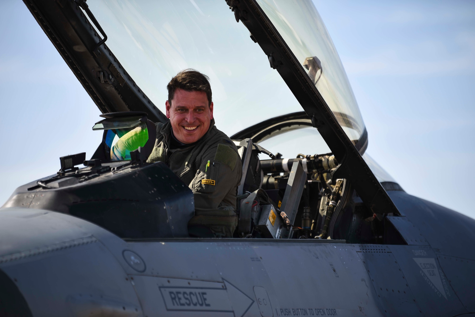 man smiling from inside a jet
