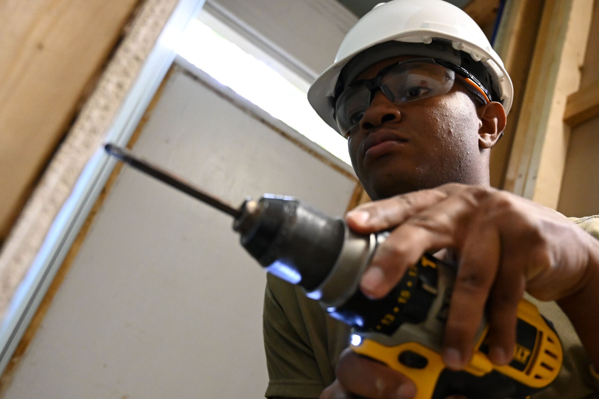 Photo of Airman using a drill.