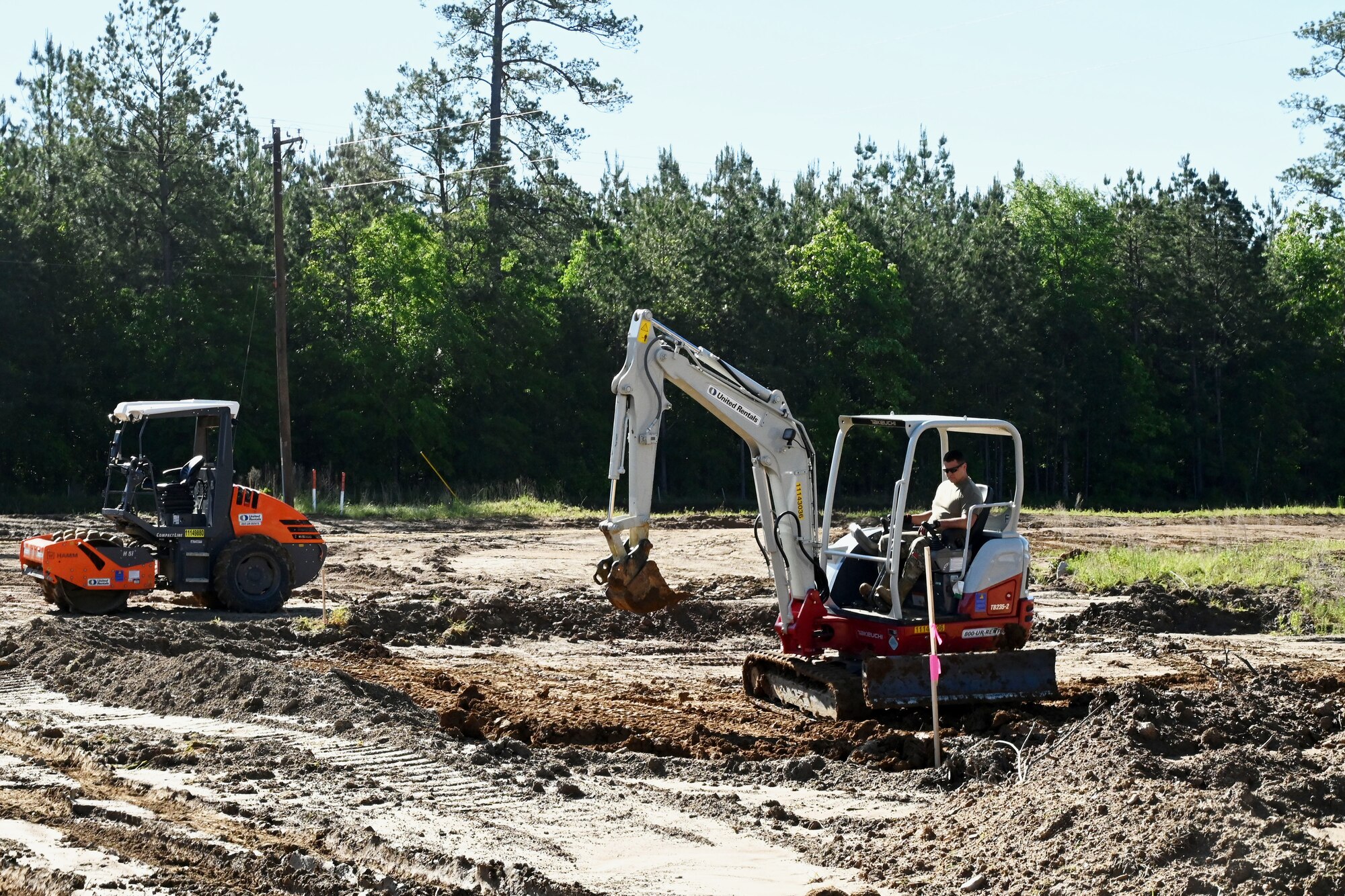 Photo of Airman working on an excavator.