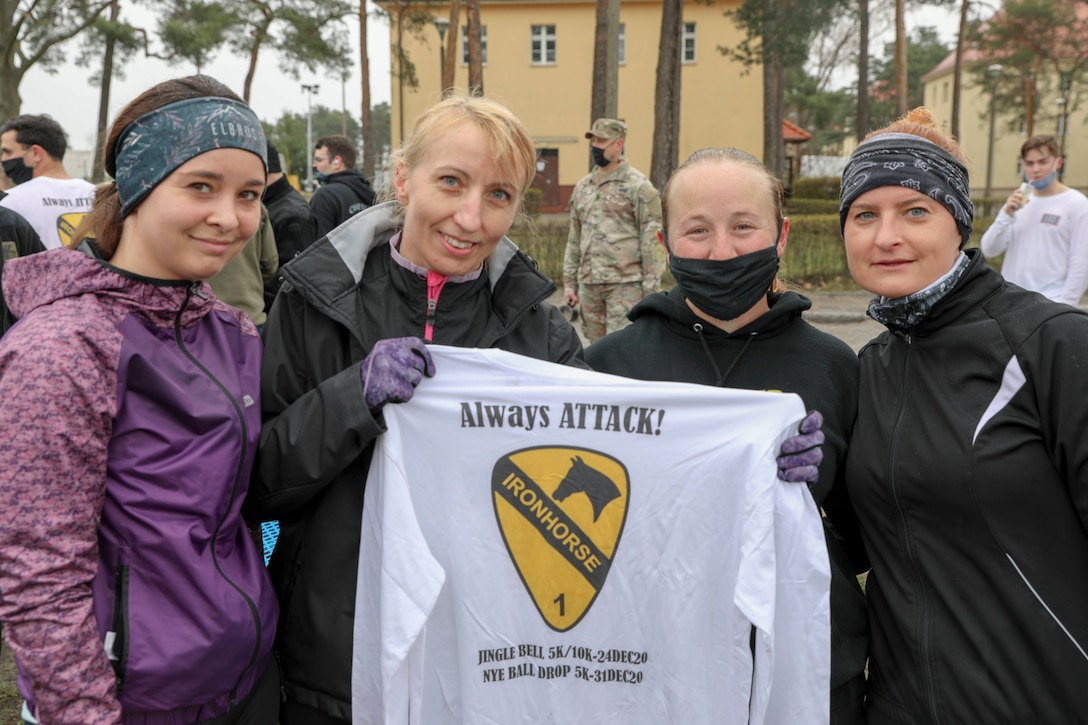 U.S. and Polish Army Soldiers exchange t-shirts and patches after competing in the inaugural Better Opportunities for Single Soldiers Poland event, a 5K competition held at Zagan Forward Operating Station, Poland, April 15, 2021. BOSS Poland is the first-ever BOSS program to be established for deployed and rotational troops, instituted by a U.S. Army Reserve civil affairs team. (Photo by Maj. Marcellus Simmons, 1-1 ABCT Public Affairs)