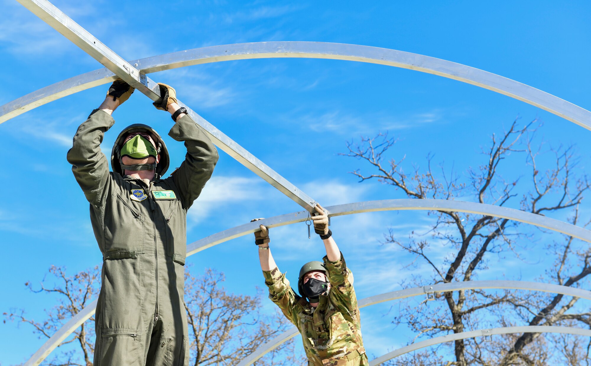 Airmen set up a military shelter system