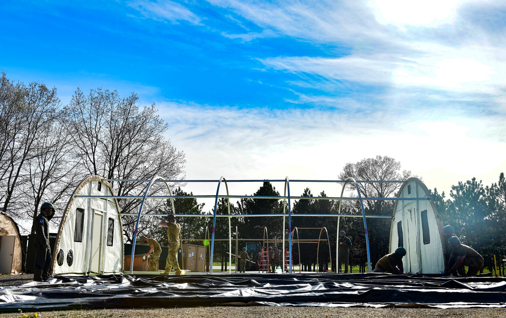 Airmen set up a military shelter system
