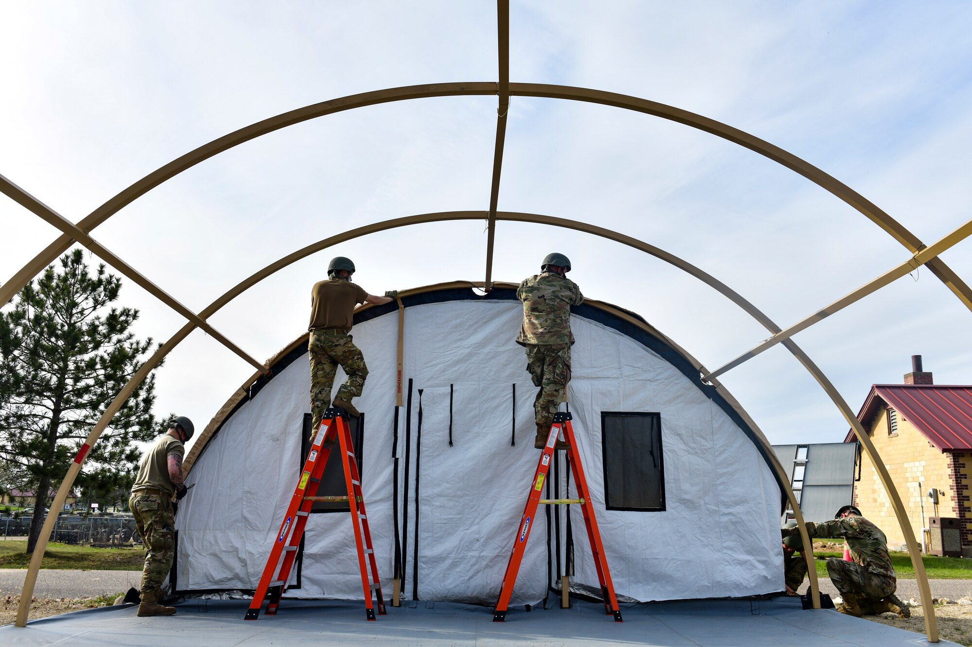 Airmen set up a military shelter system