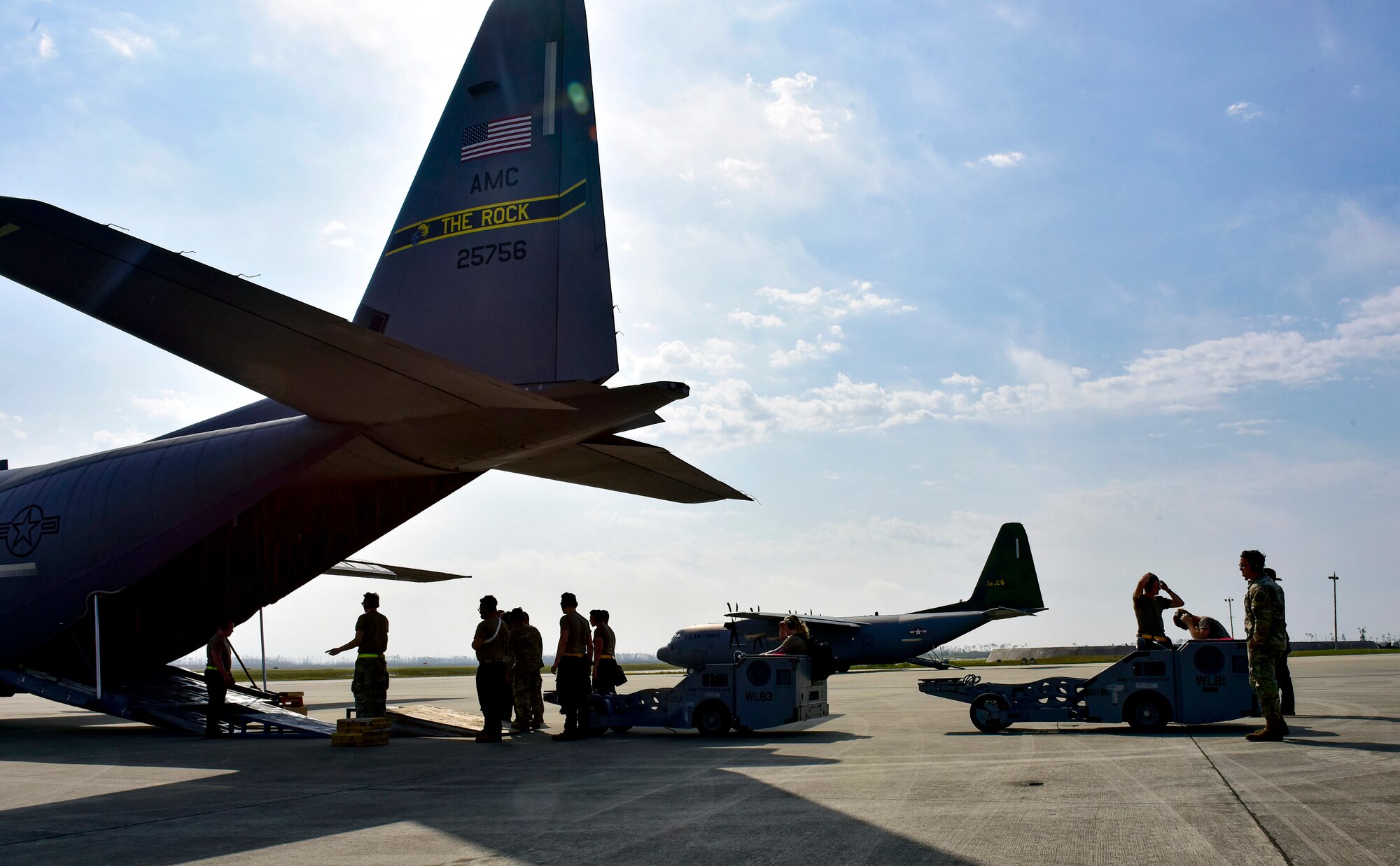 Airmen load two MJ-1 Bomb Lifter “Jammers” onto a C-130J Super Hercules