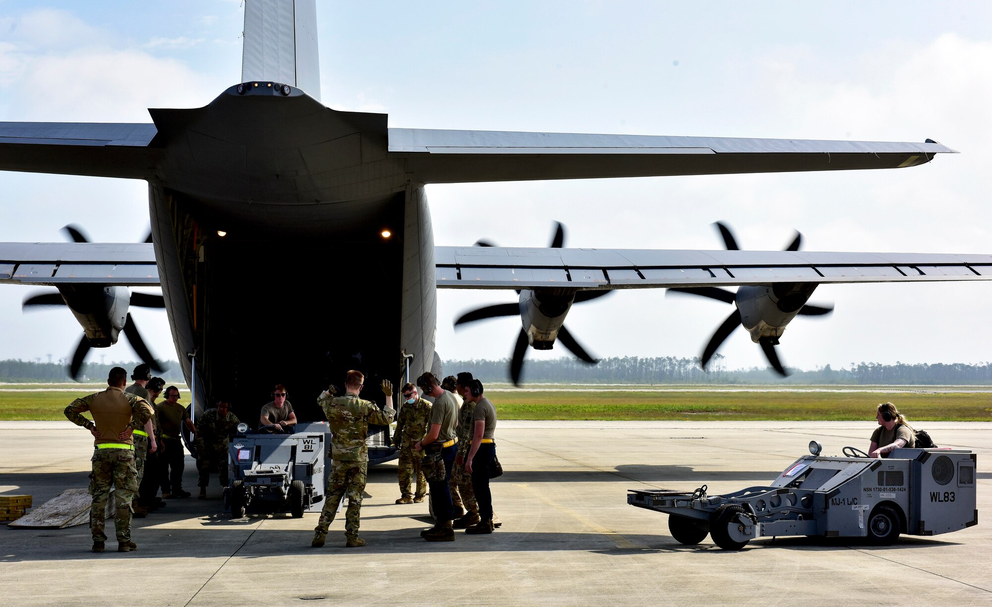 Airmen load two MJ-1 Bomb Lifter “Jammers” onto a C-130J Super Hercules