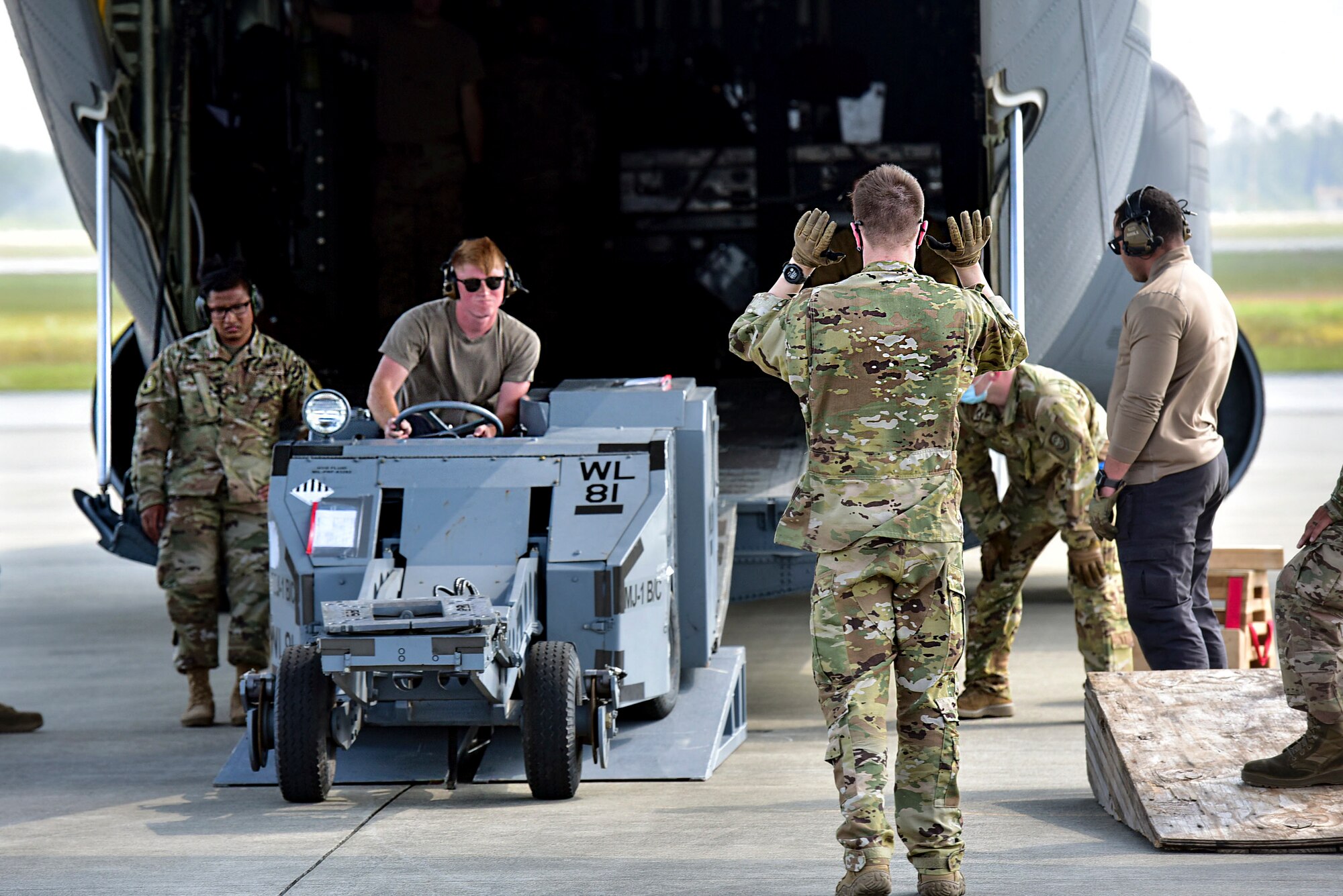Airmen load a MJ-1 Bomb Lifter “Jammers” onto a C-130J Super Hercules
