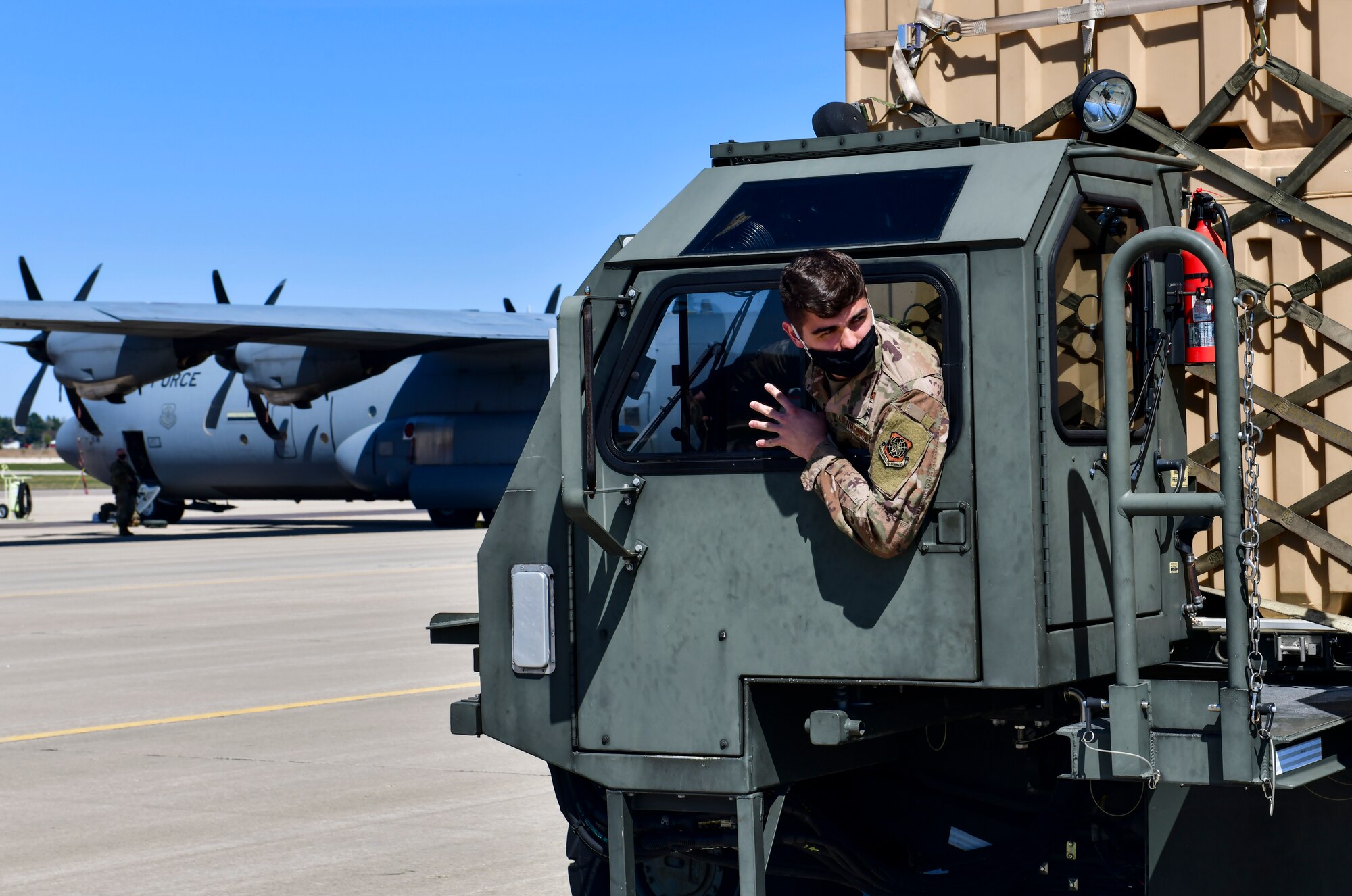 An Airman assigned to the 19th Logistics Readiness Squadron backs up a K-loader after offloading cargo from a C-130J Super Hercules