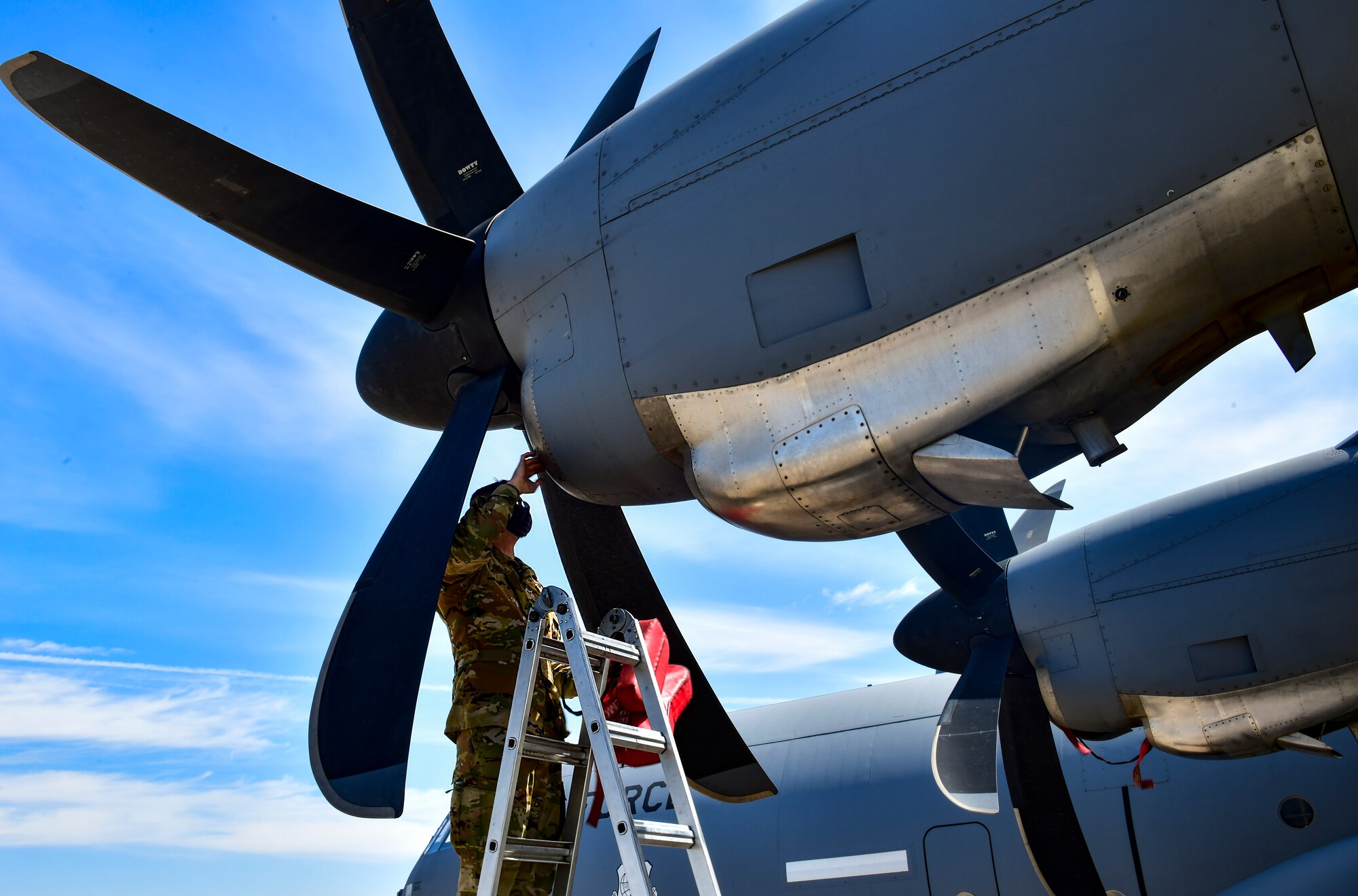 An Airman assigned to the 19th Airlift Wing conducts a post-flight check of a C-130J Super Hercules