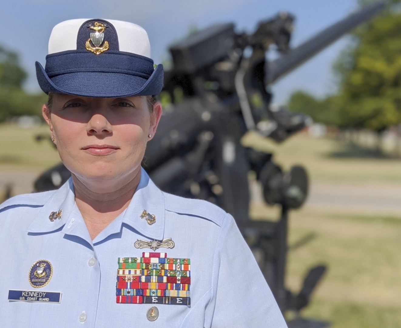 U.S. Coast Guard Master Chief Petty Officer Laurie A Kennedy, the gunner’s mate rating force master chief, stands in front of a decommissioned canon after being pinned master chief at the Coast Guard Yard in Baltimore, July 21, 2020. Kennedy was the first female gunner’s mate to be pinned master chief in Coast Guard history.
(U.S. Coast Guard photo by Petty Officer 3rd Class Ronald Hodges)