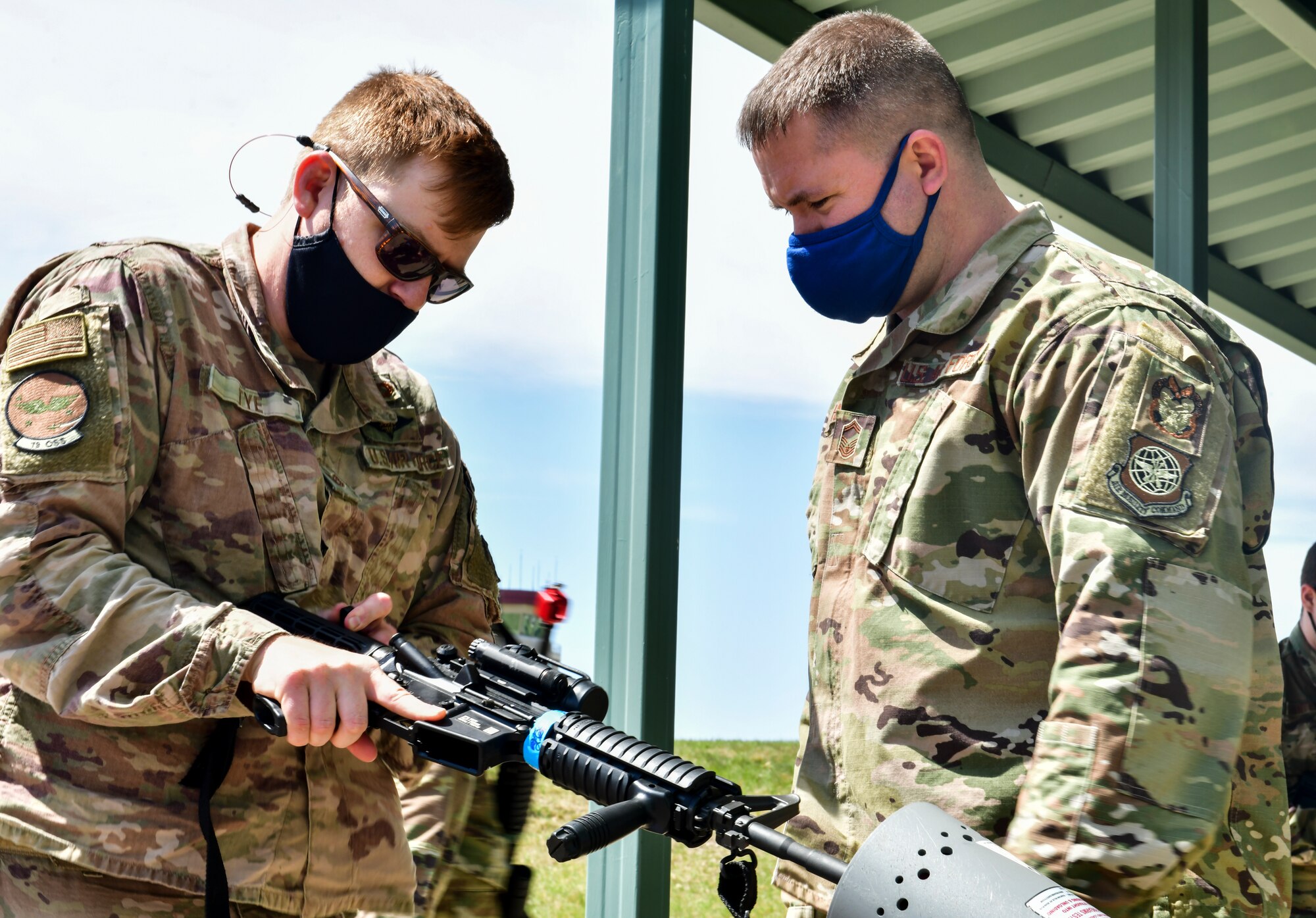 An Airman assigned to the 19th Airlift Wing clears his M-4 rifle