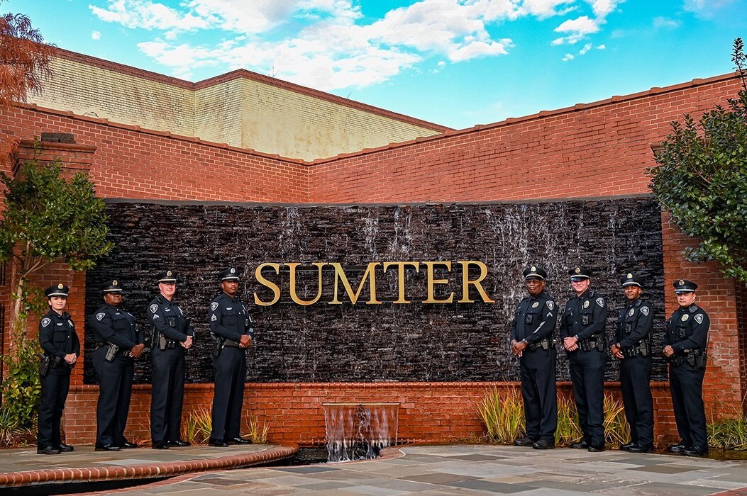 A photo of police officers standing in front of a sign