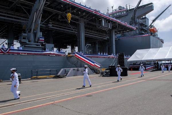 The crew of USS Miguel Keith (ESB 5) prepare to board the ship during the ship’s commissioning ceremony.