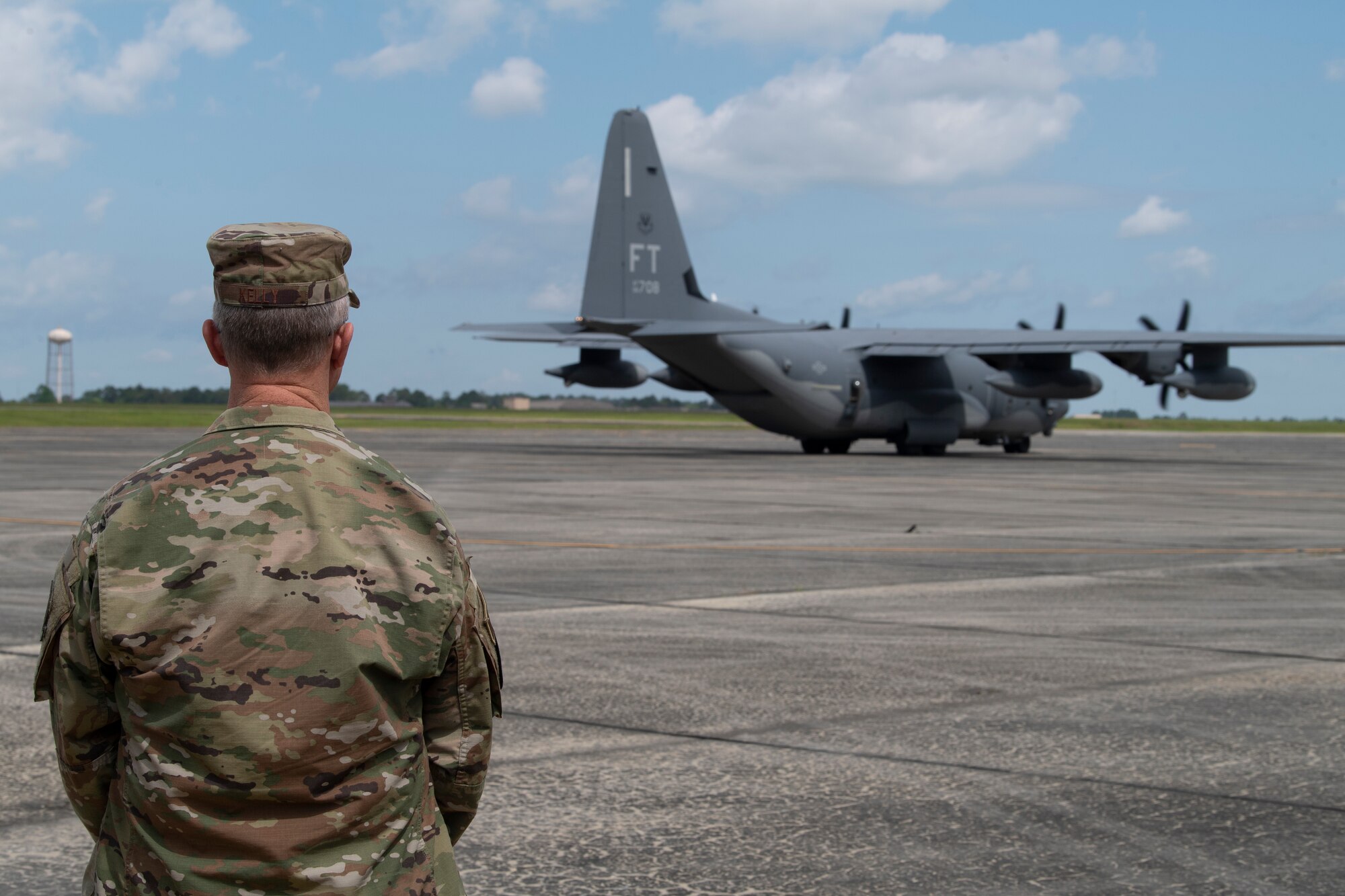 A photo of Gen. Kelly standing behind a C-130J Combat King II.