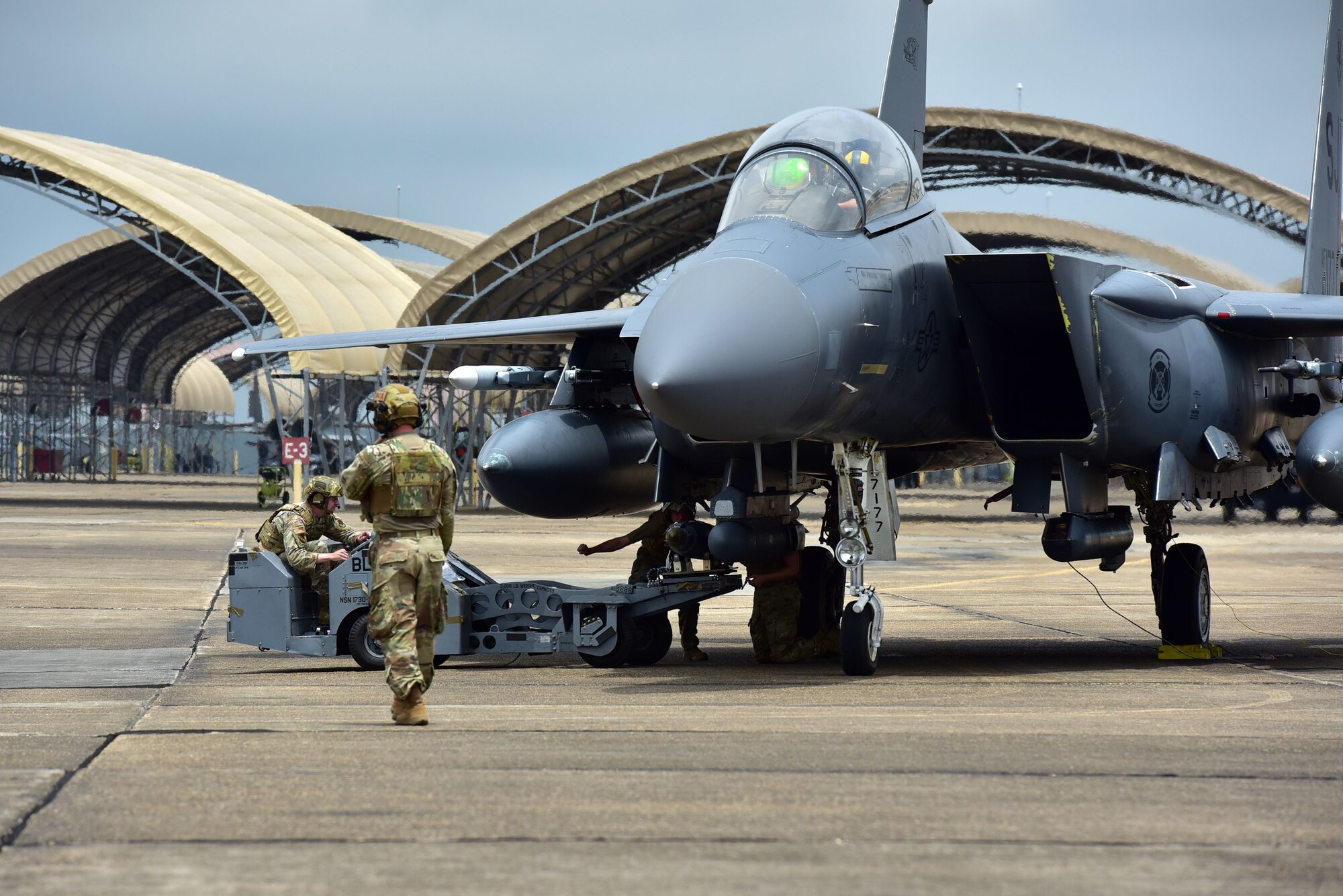An inert munition is loaded onto a F-15E Strike Eagle