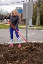 210417-N-EJ843-0005 GROTON, Conn. (April 17, 2021) Sarah Simons removes old soil before planting new plants outside of Naval Submarine Base (SUBASE) New London. The Simons’ started a beautification project on base after seeing trash and the need for improvement in certain areas. With a love for finding ways to make the community look better, the Simons’ noticed the outside of the base didn’t have many flowers or shrubs. After talking to SUBASE Public Works, the Town of Groton, and the state Department of Transportation they received approval for their beautification project near the base’s Main Gate. (U.S. Navy photo by Mass Communications Specialist Seaman Jimmy Ivy III/Released)