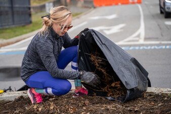 210417-N-EJ843-0005 GROTON, Conn. (April 17, 2021) Sarah Simons removes old soil before planting new plants outside of Naval Submarine Base (SUBASE) New London. The Simons’ started a beautification project on base after seeing trash and the need for improvement in certain areas. With a love for finding ways to make the community look better, the Simons’ noticed the outside of the base didn’t have many flowers or shrubs. After talking to SUBASE Public Works, the Town of Groton, and the state Department of Transportation they received approval for their beautification project near the base’s Main Gate. (U.S. Navy photo by Mass Communications Specialist Seaman Jimmy Ivy III/Released)