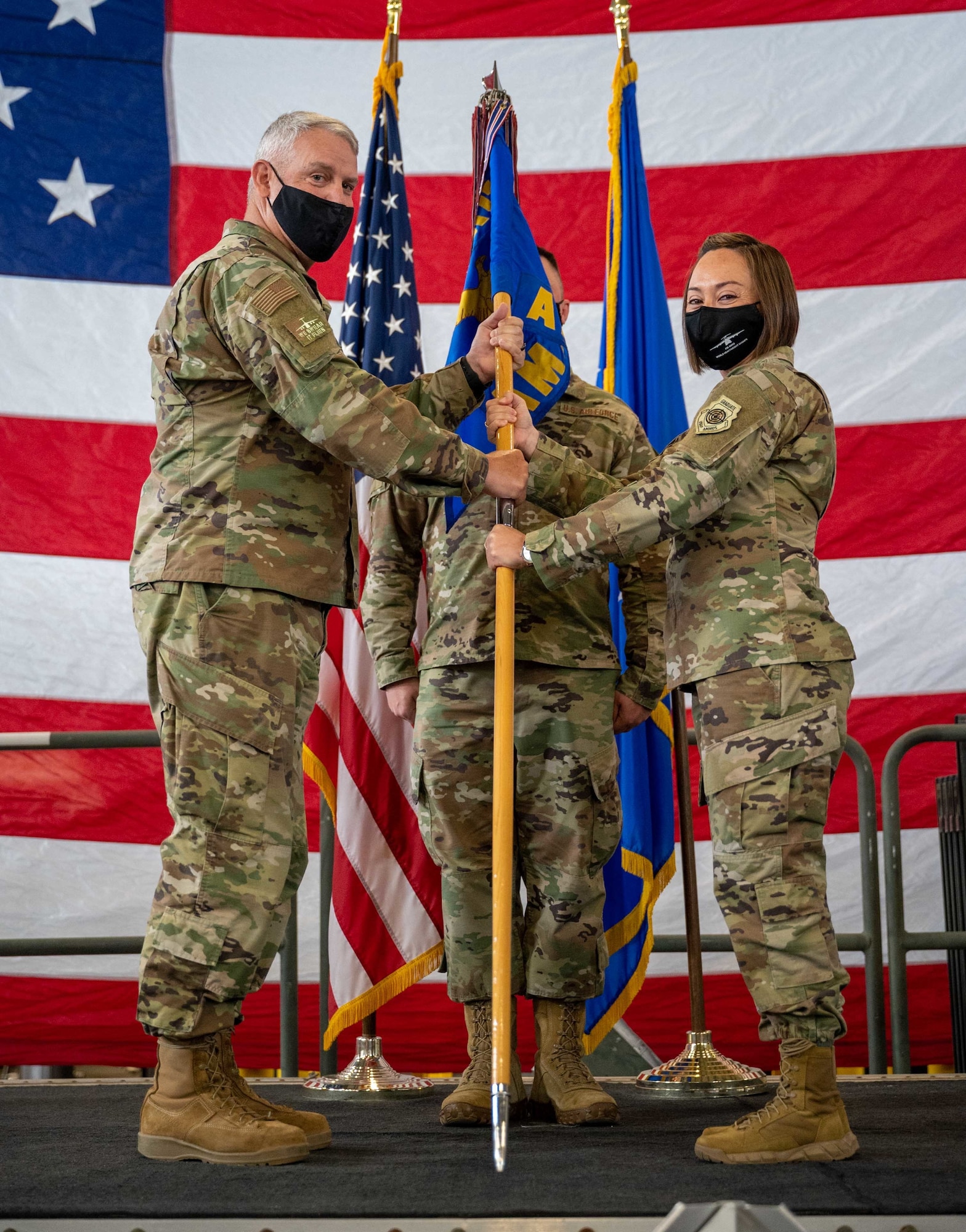 Col. Christopher May, 436th Maintenance Group commander, passes the 436th Aircraft Maintenance Squadron guidon to Lt. Col. Josephine Beacham, incoming 436th AMXS commander, at a change of command ceremony on Dover Air Force Base, Delaware, May 7, 2021. Beacham took command from Lt. Col. Jason Purcell. The squadron is responsible for the inspection, repair, launch and recovery of Dover AFB’s C-5M Super Galaxy fleet.  (U.S. Air Force photo by Airman 1st Class Faith Schaefer)