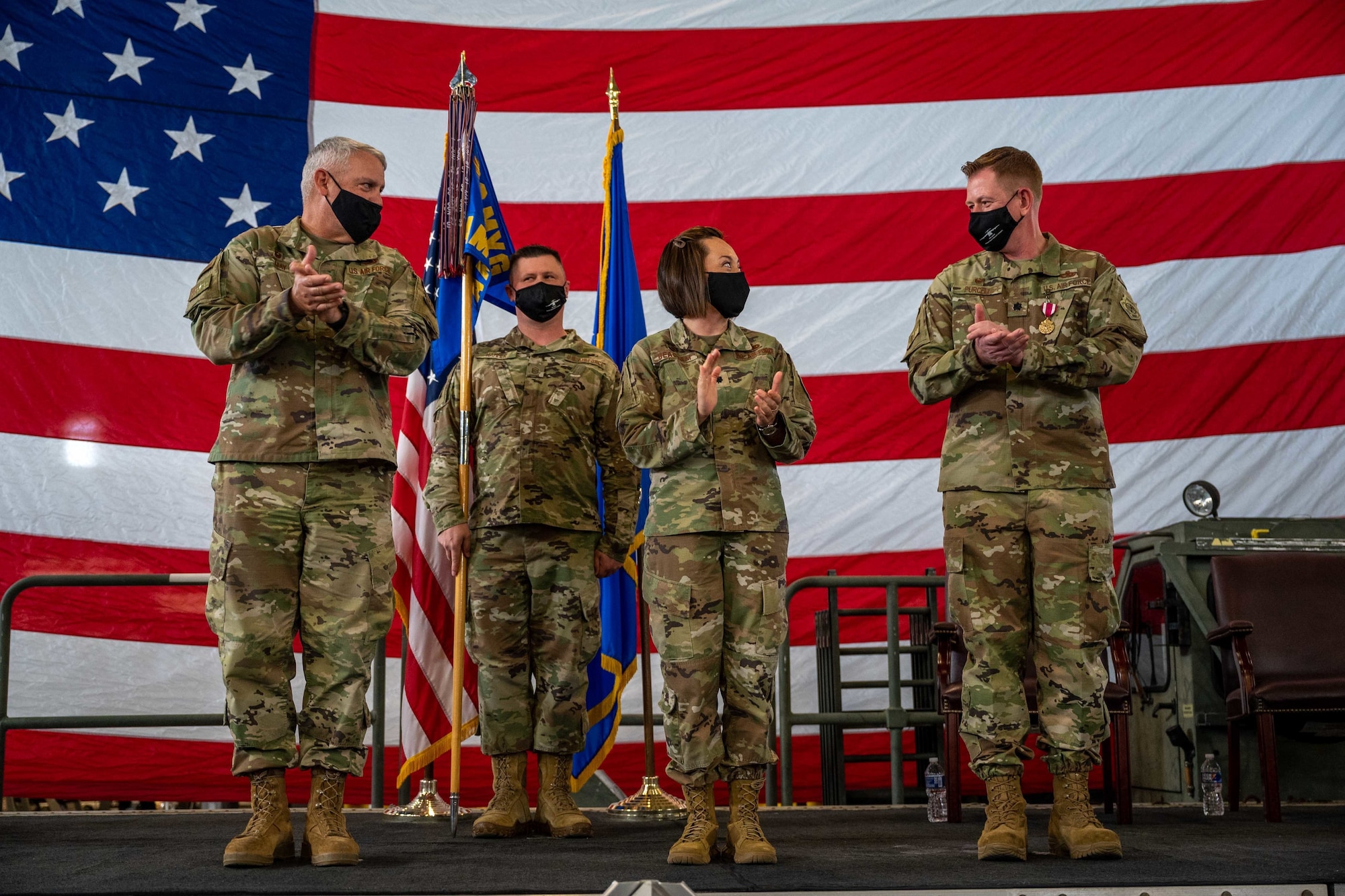 From the left, Col. Christopher May, 436th Maintenance Group commander, stands with Lt. Col. Josephine Beacham, incoming 436th Aircraft Maintenance Squadron commander and Lt. Col. Jason Purcell, outgoing 436th  AMXS commander, at a change of command ceremony on Dover Air Force Base, Delaware, May 7, 2021. During the ceremony, Purcell relinquished command to Beacham. (U.S. Air Force photo by Airman 1st Class Faith Schaefer)