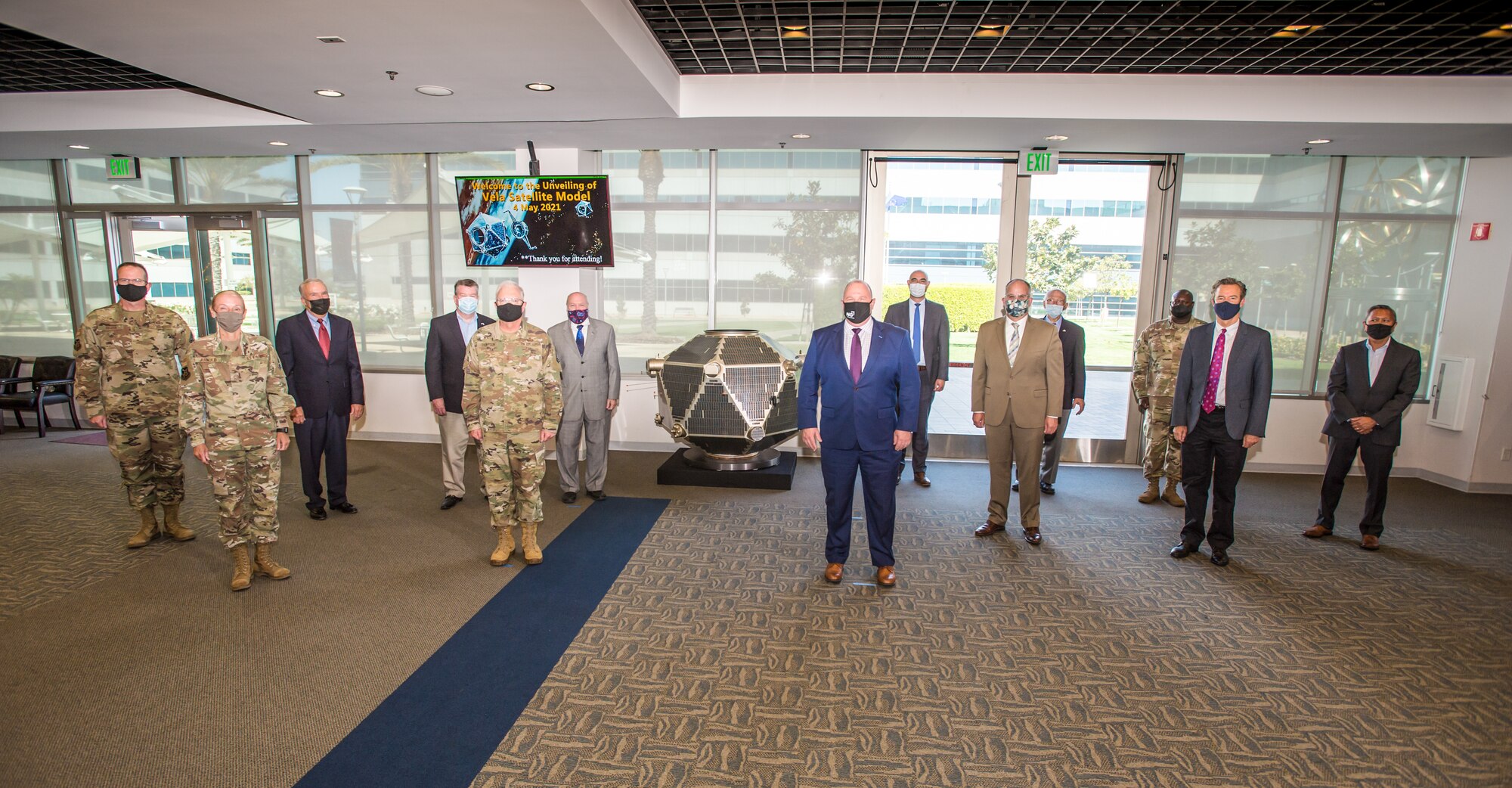 Representatives from the Space and Missile Systems Center and Northrop Grumman gathered on for the unveiling of a full-scale Vela satellite model presented by Northrop Grumman for permanent display at Los Angeles Air Force Base, California, May 4, 2021. Originated in 1960, Vela was the first space-based system used for nuclear surveillance. Today, the mission of monitoring nuclear detonations continues with payloads hosted on GPS satellites. (U.S. Space Force photo by Van Ha)