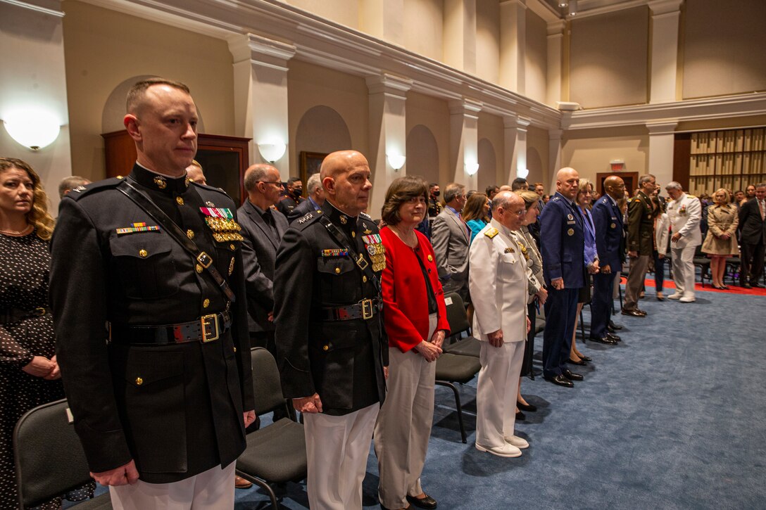 Gen. David H. Berger, center, 38th Commandant of the Marine Corps, and Col. Teague A. Pastel, left, commanding officer of Marine Barracks Washington, stand at attention alongside the guests of honor during the Friday Evening Parade at MBW, D.C., May 7, 2021. The 38th Commandant of the Marine Corps Gen. David H. Berger hosted the ceremony, and the following service chiefs were the guests of honor: Chief of Naval Operations Adm. Michael Gilday, Chief of Space Operations Gen. John W. "Jay" Raymond, Chief of Staff of the U.S. Air Force Gen. Charles Q. Brown, Jr., Chief of the National Guard Bureau Gen. Daniel R. Hokanson, and Commandant of the U.S. Coast Guard Adm. Karl L. Schultz. (U.S. Marine Corps photo by Lance Cpl. Tanner D. Lambert)