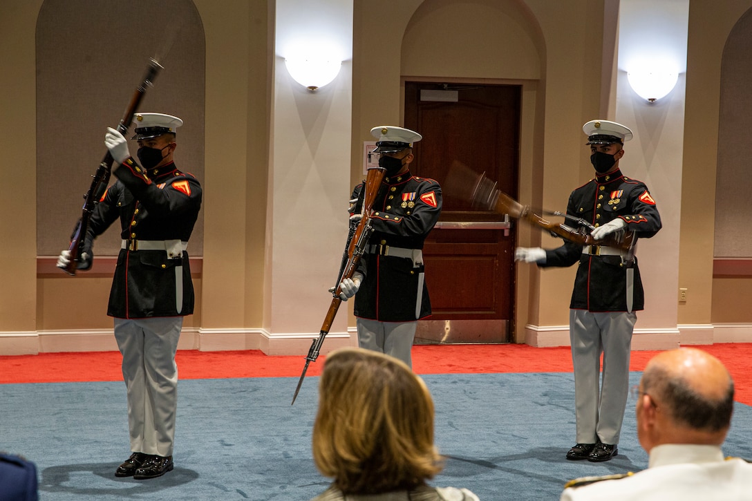 From left to right, Lance Cpls. Tristan Barlow, Benjamin Lagos and Edward Fernandez, riflemen, Silent Drill Platoon, perform during the Friday Evening Parade at Marine Barracks Washington, D.C., May 7, 2021.