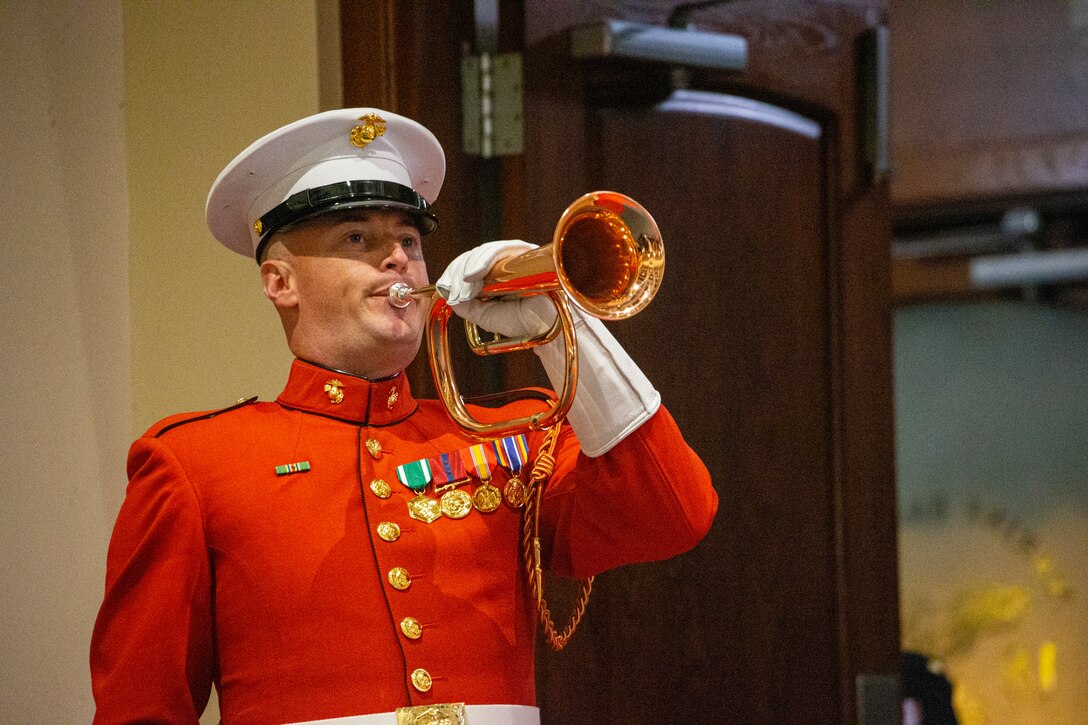 Staff Sgt. Christopher Walker, ceremonial bugler, “The Commandant’s Own” United States Marine Drum and Bugle Corps, plays “Taps” during the Friday Evening Parade at Marine Barracks Washington, D.C., May 7, 2021.