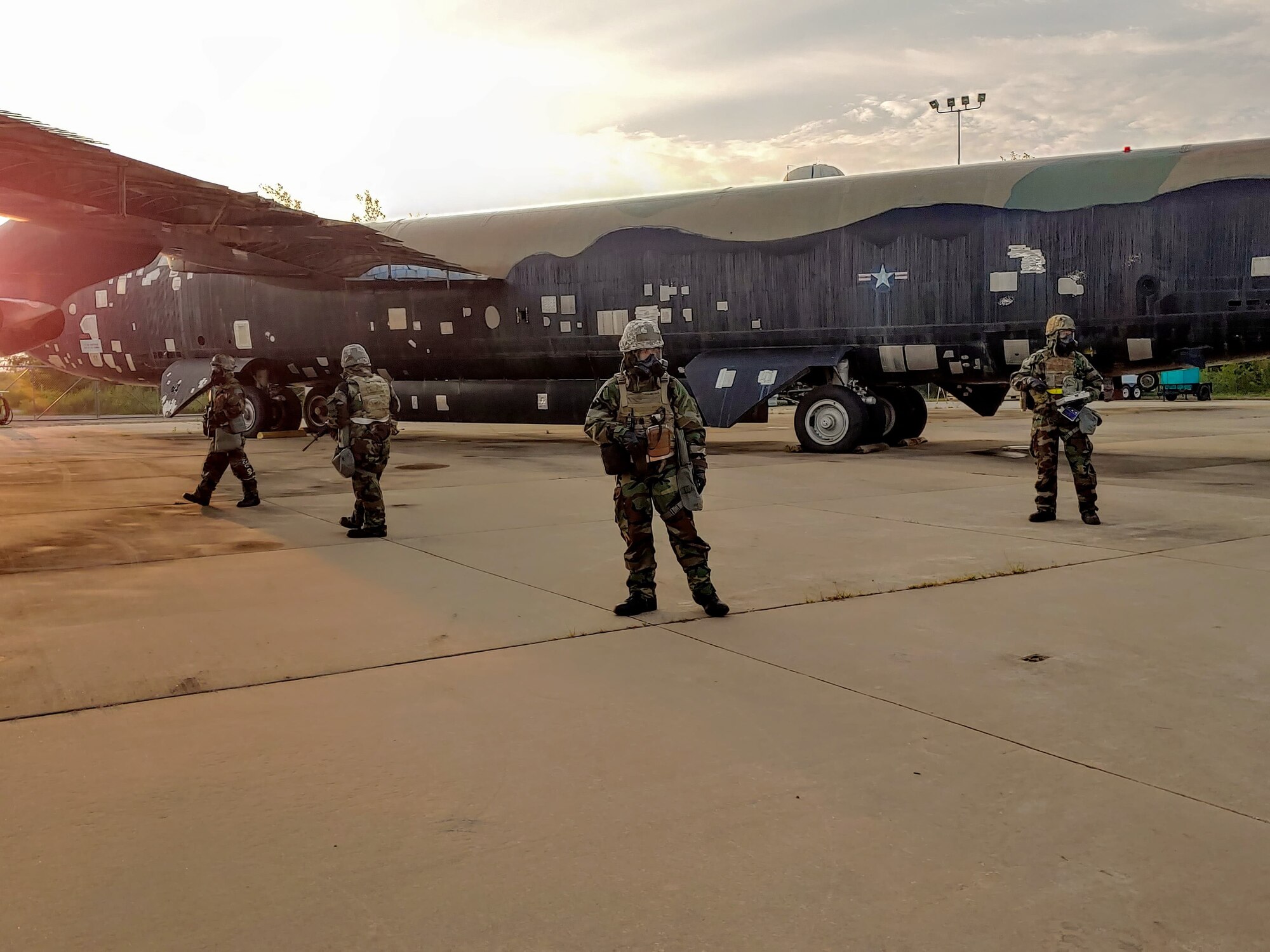 Airmen standing in front of equipment